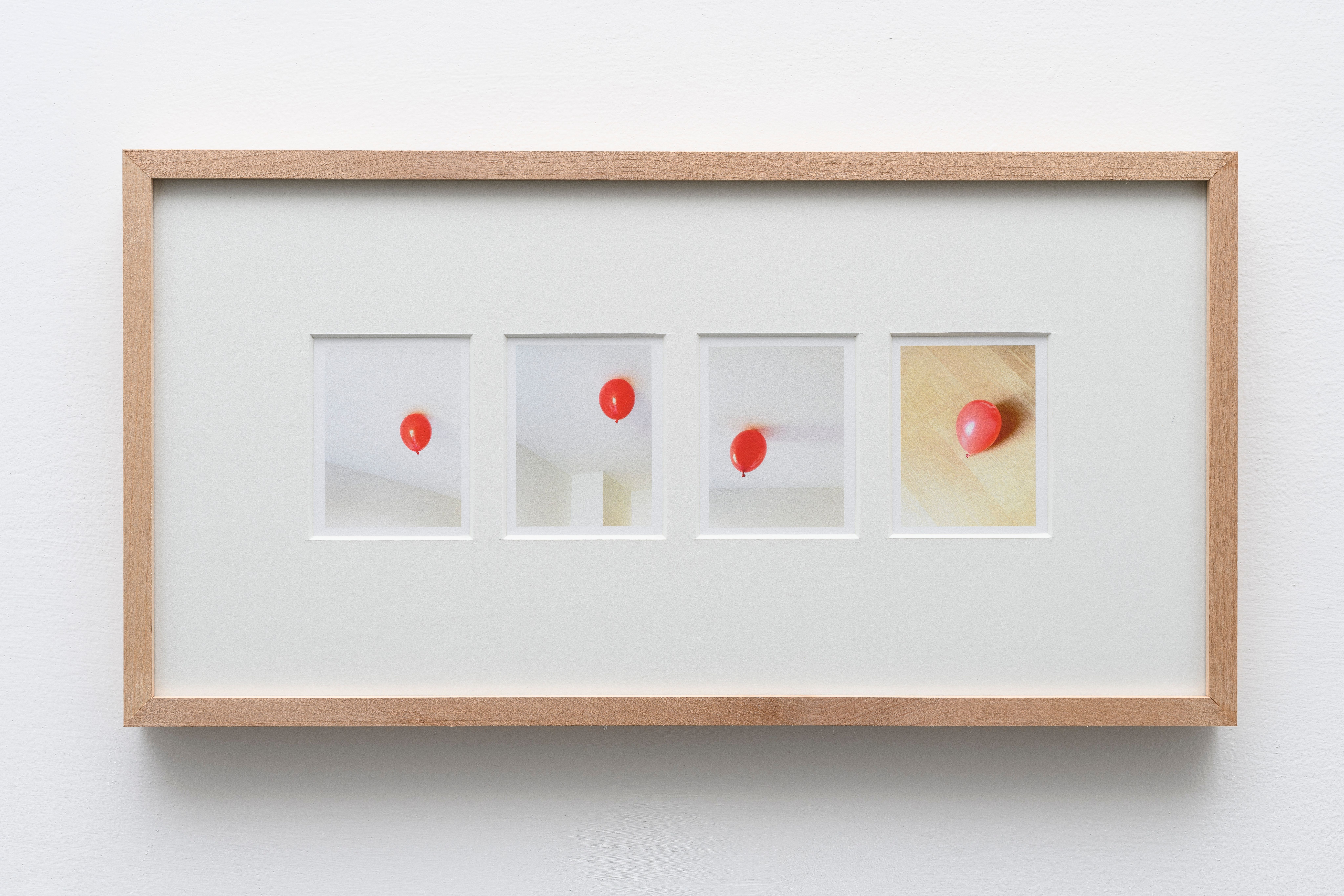 Framed sequence of four photos of a red balloon stuck to a ceiling