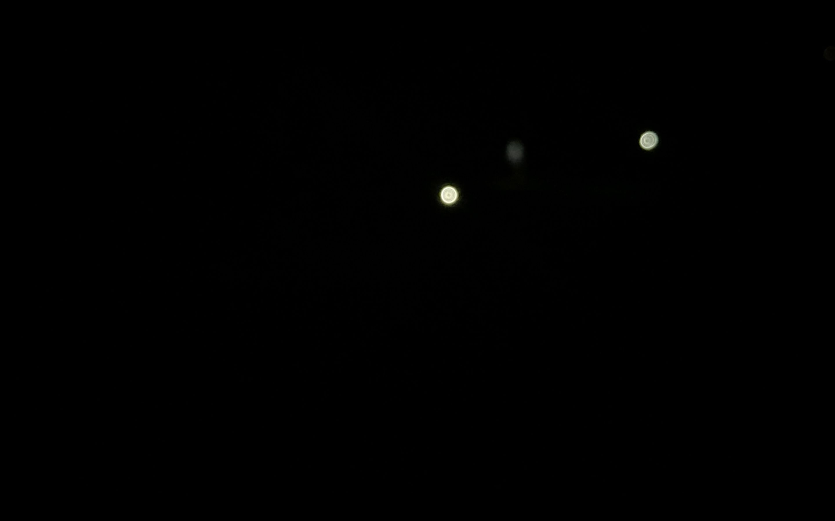 Video still: torchlights moving in the dark