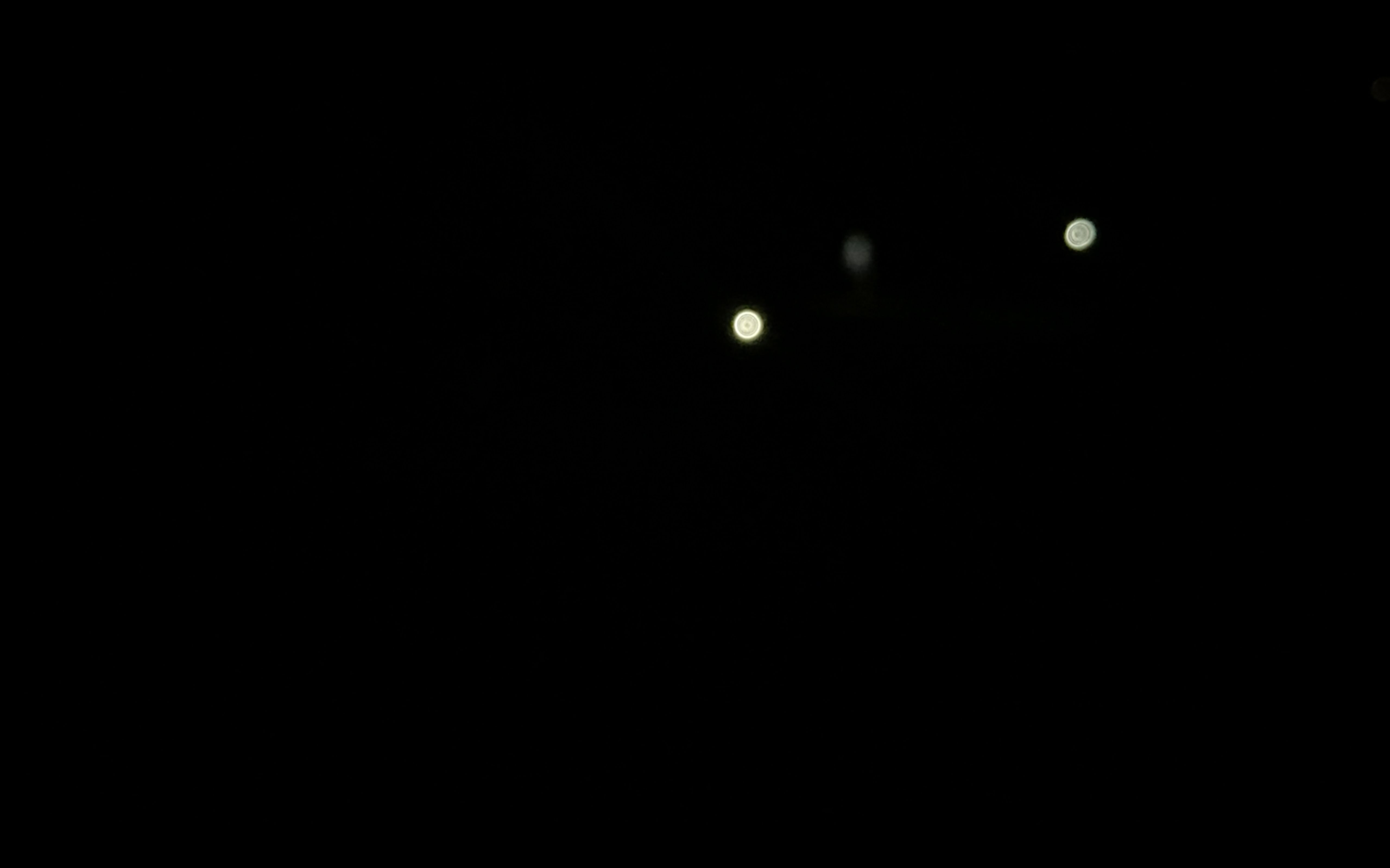 Video still: torchlights moving in the dark