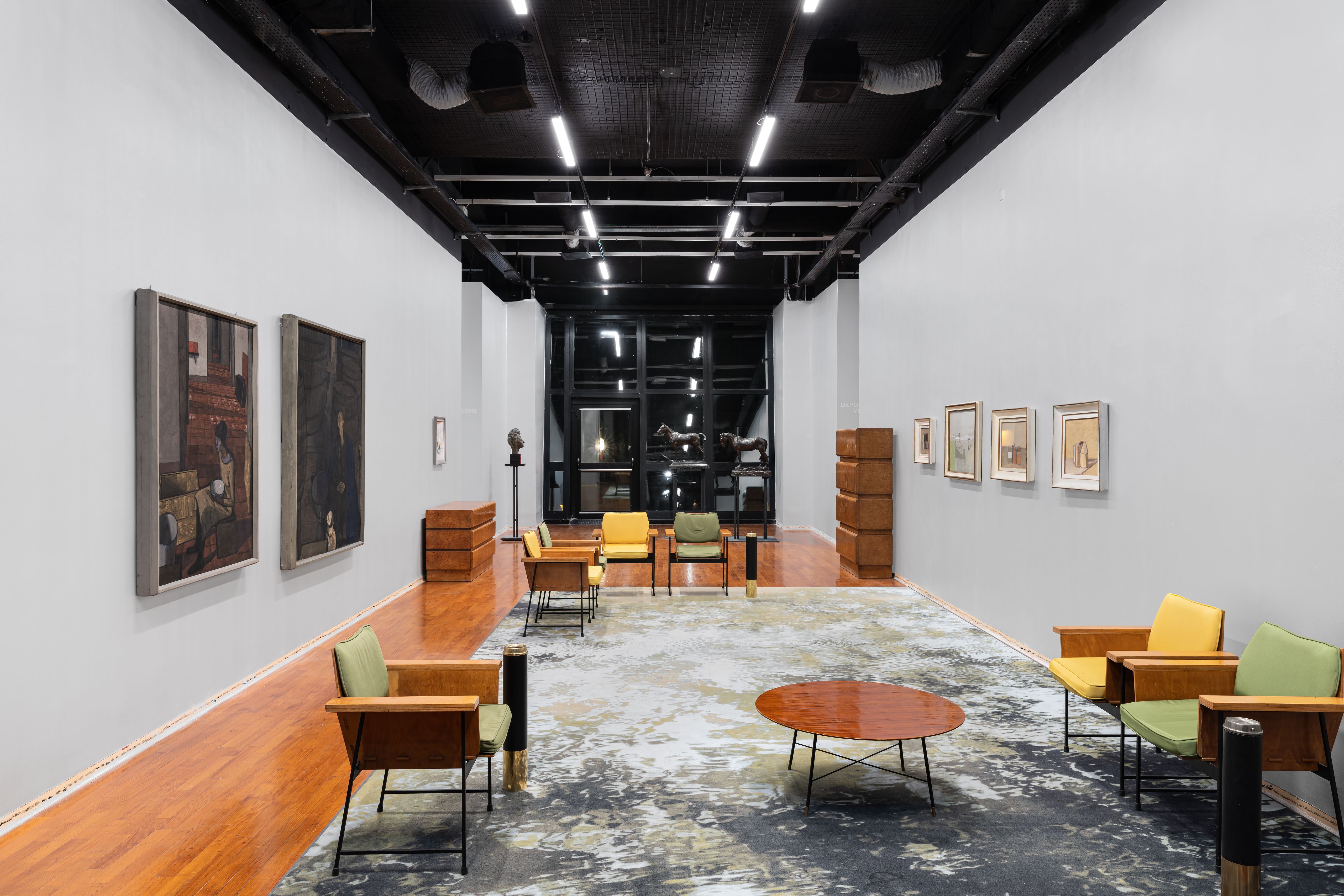 Museum gallery with armchairs and paintings, stars printed along the base of the walls