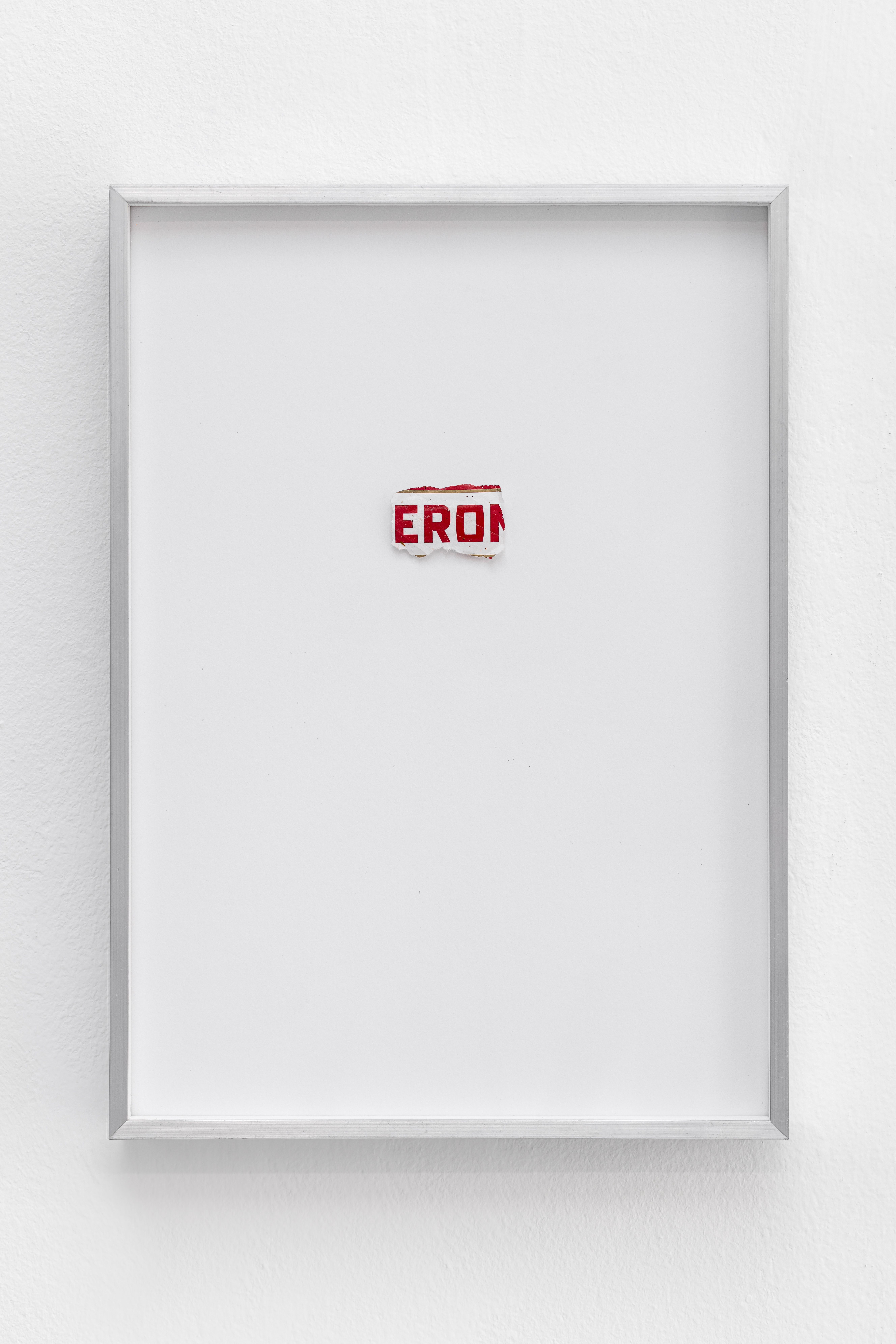 Framed torn beer label fragment reading EROI on white paper