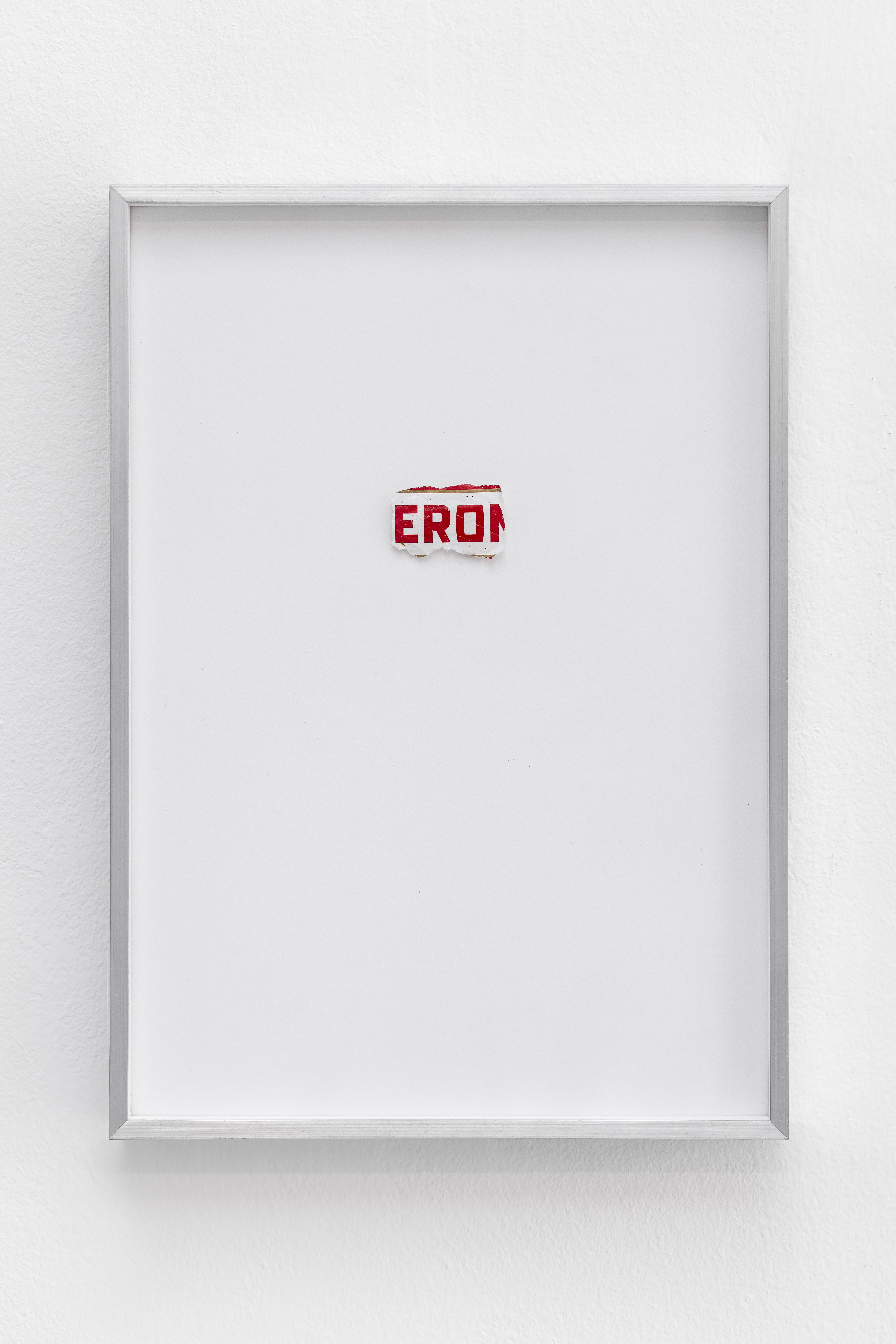 Framed torn beer label fragment reading EROI on white paper