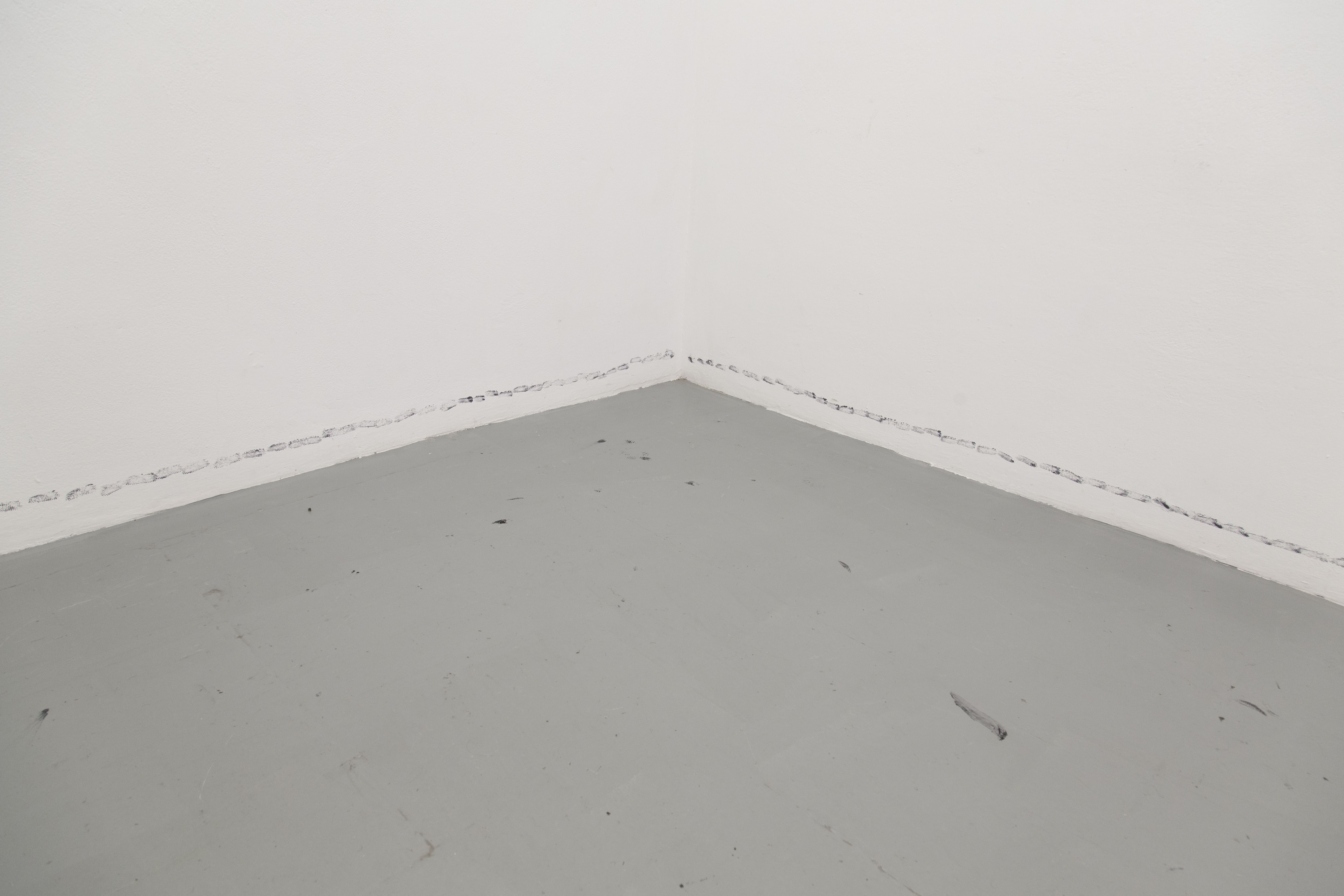 Corner of a white room with star prints along the base of the walls