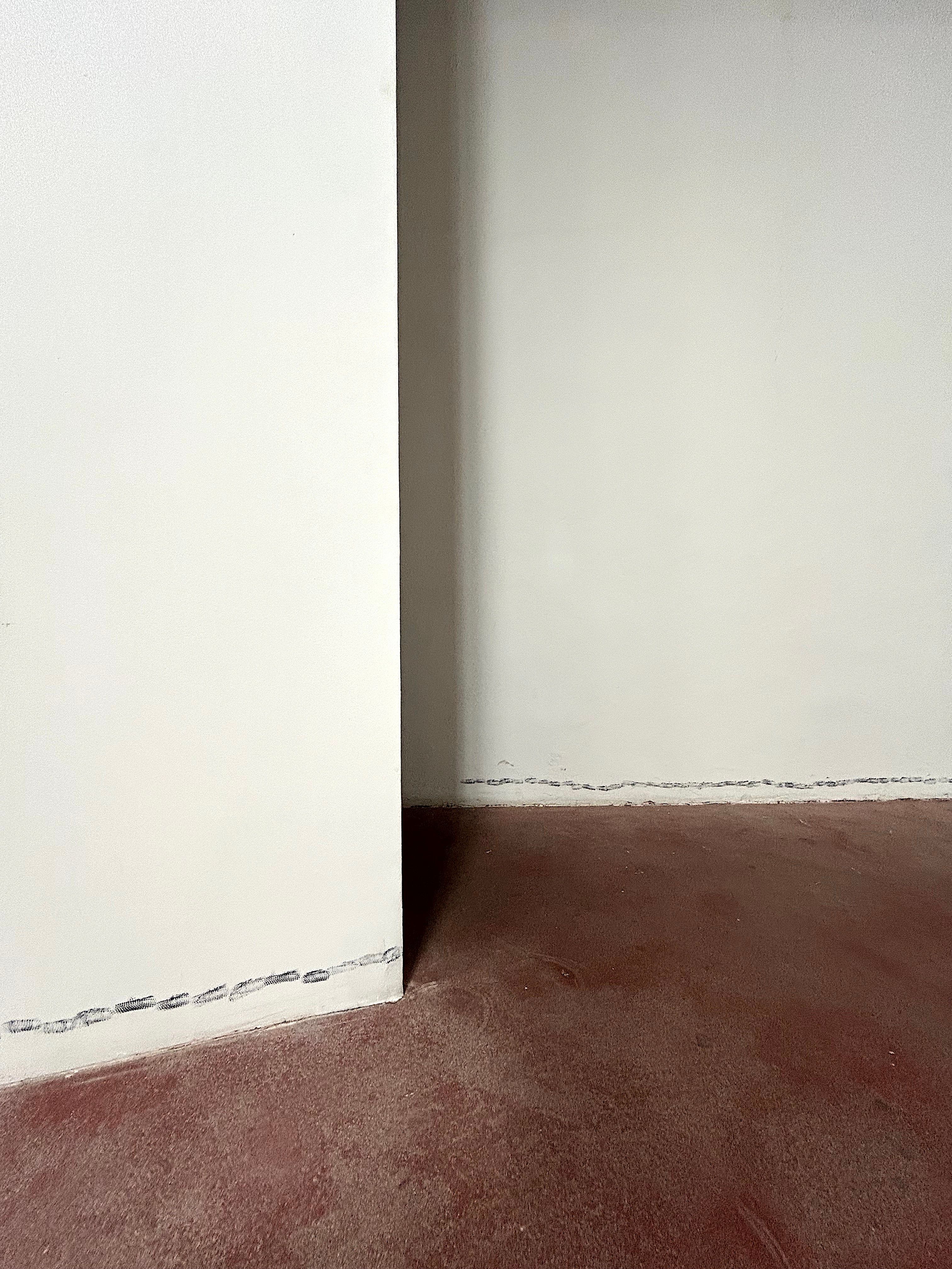White wall edge with shoe prints along the bottom