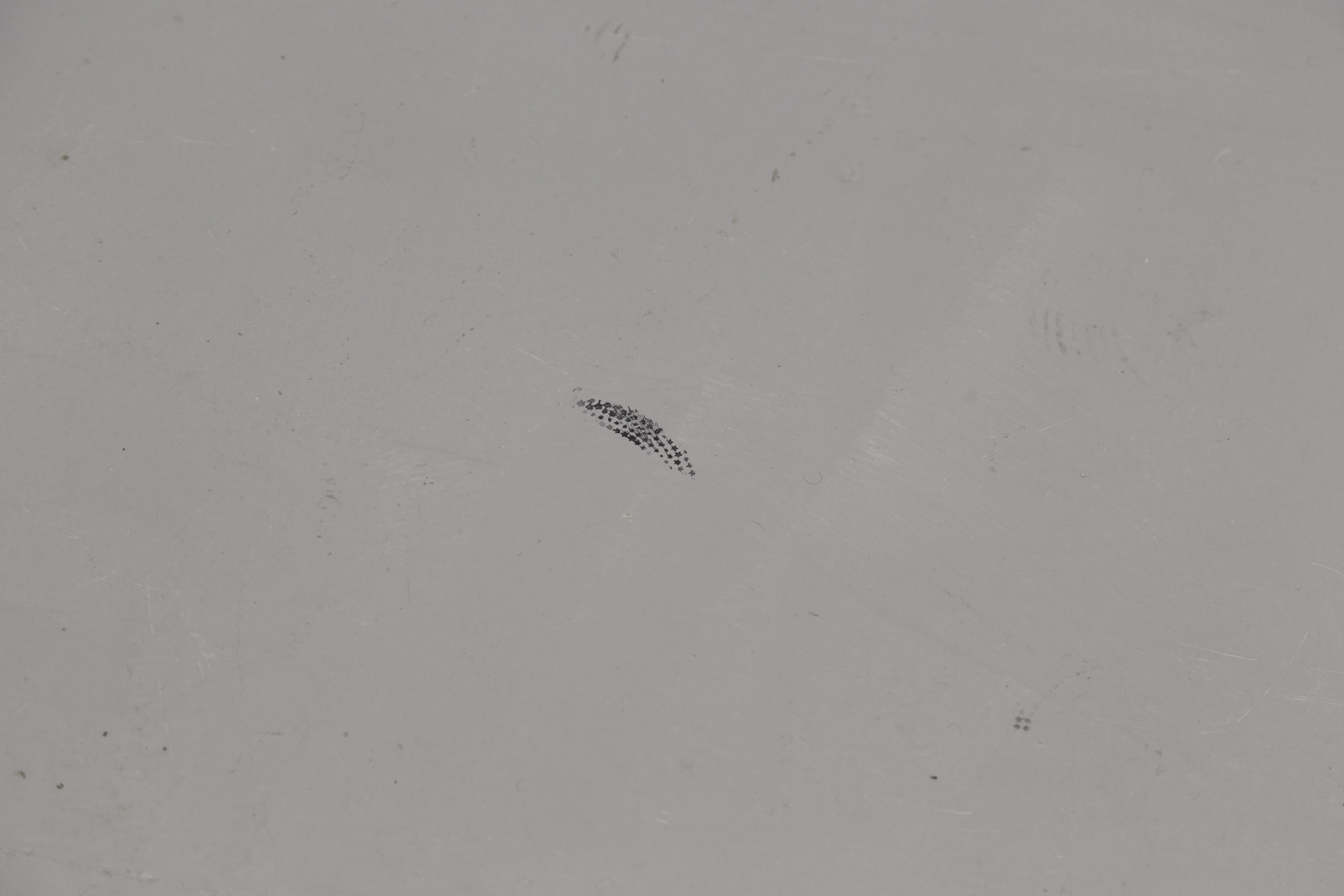 Small black star print on a grey floor