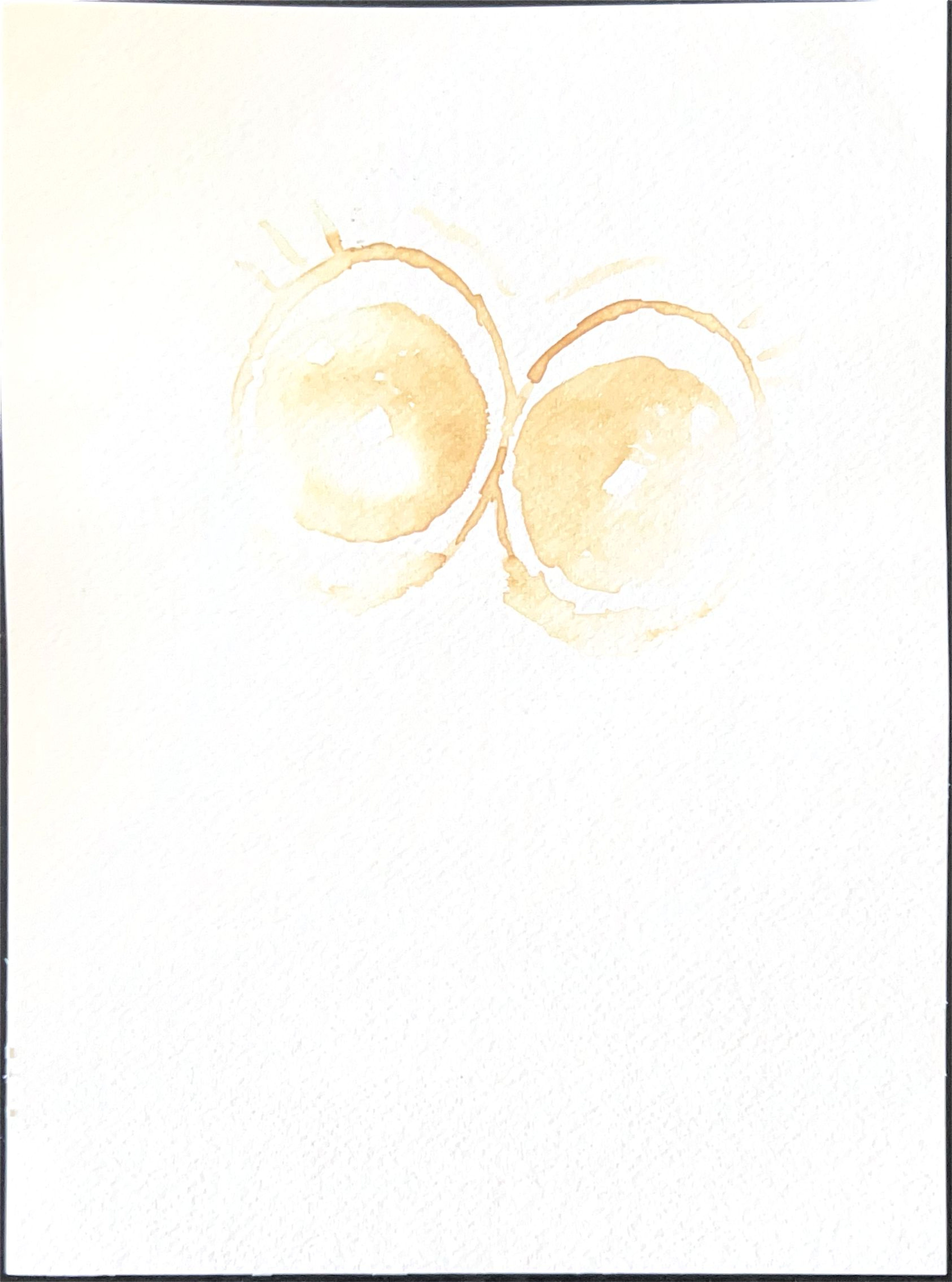 Drawing of two round eyes in burnt lemon juice on white paper