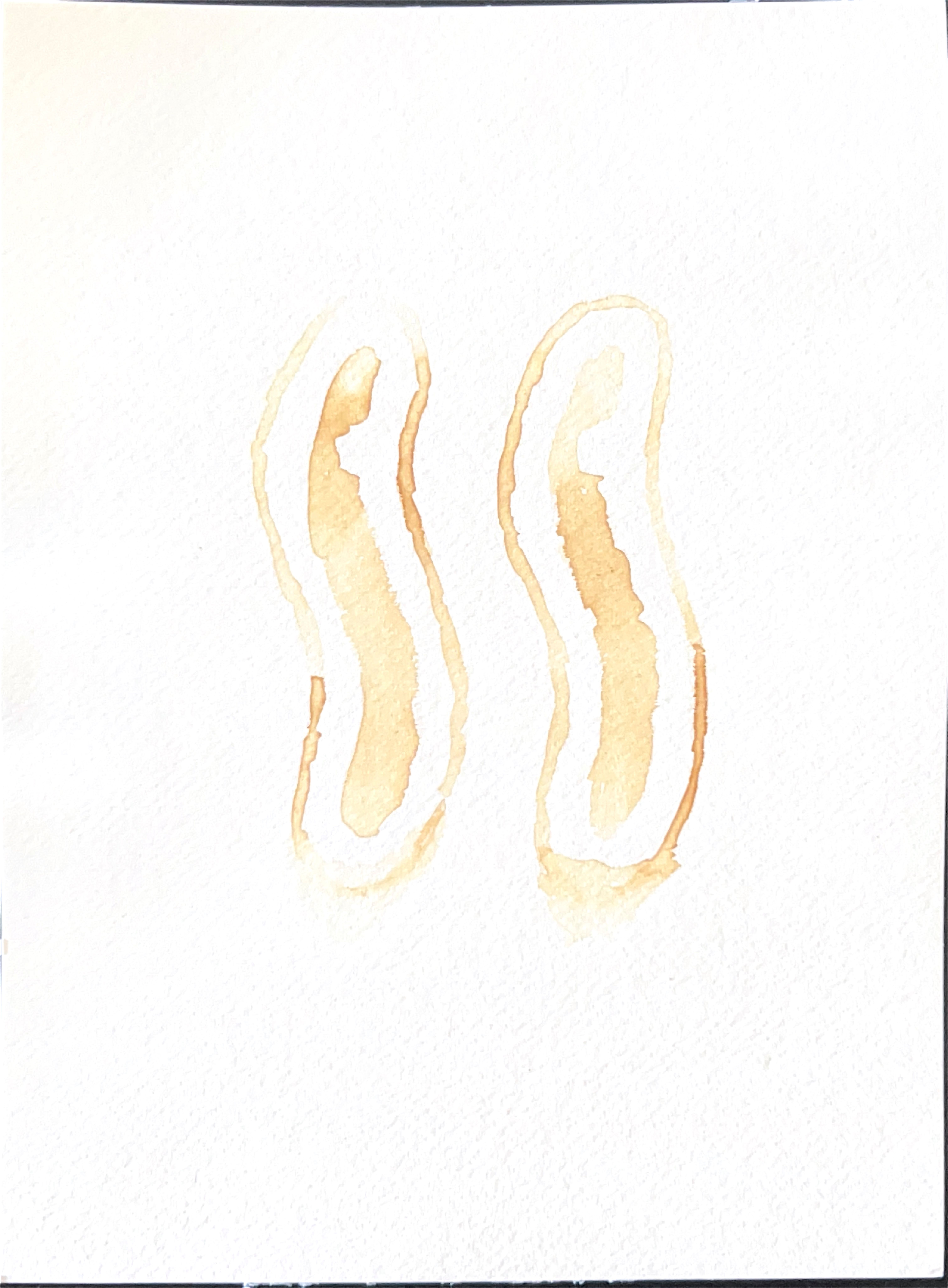 Drawing of two elongated eye shapes in burnt lemon juice on white paper