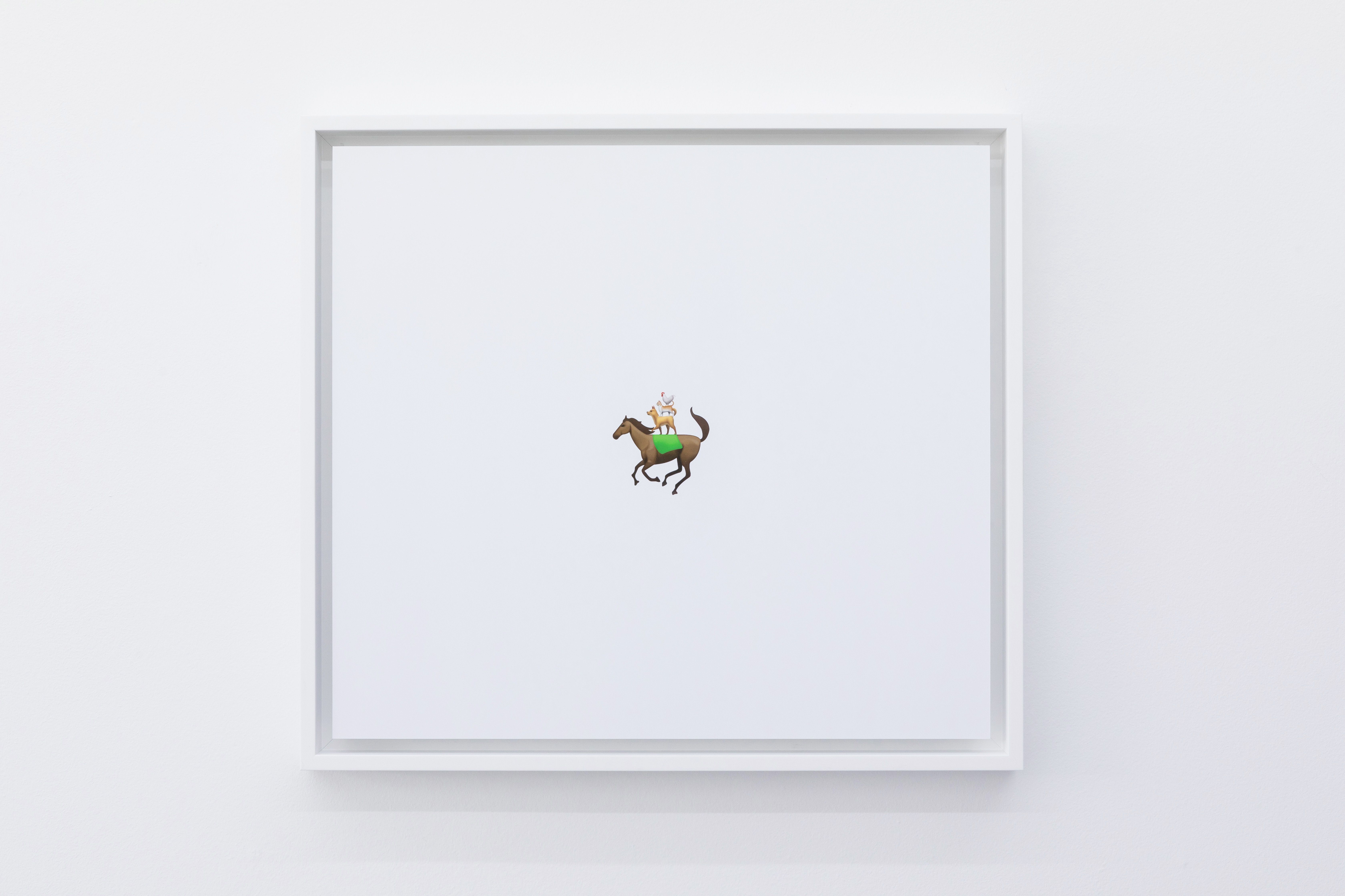 Small framed drawing of a horse and rider on a white wall
