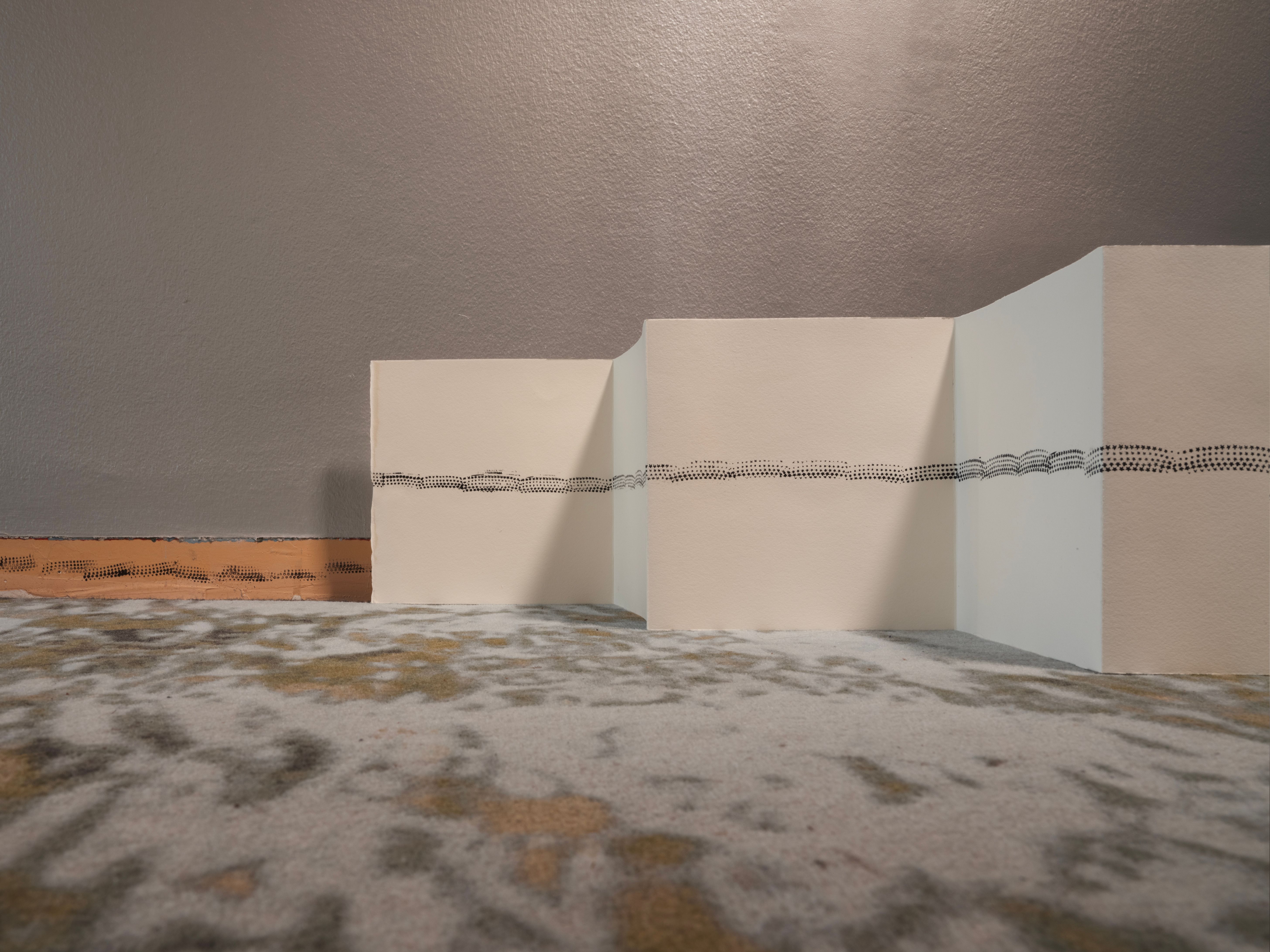 Leporello book standing in zigzag folds on a carpet