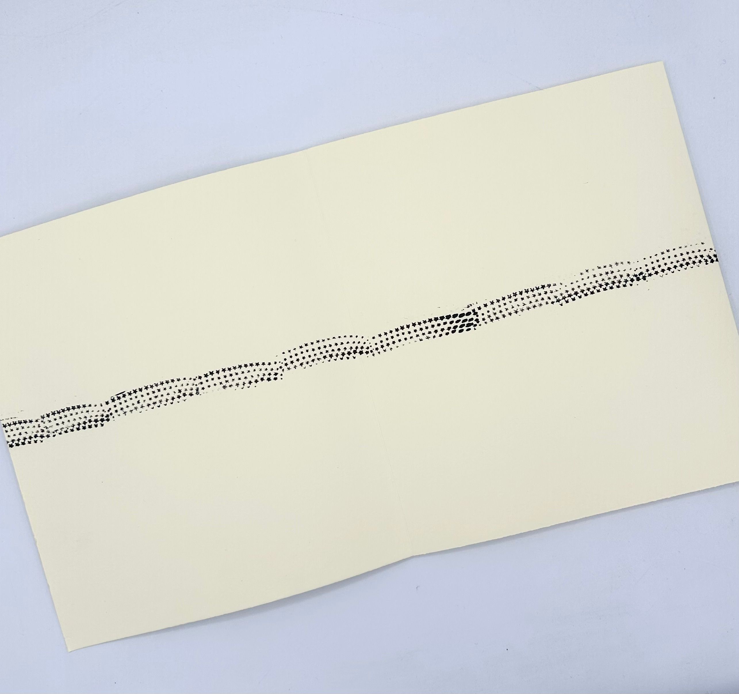 Cream sheet with a wavy band of black star prints