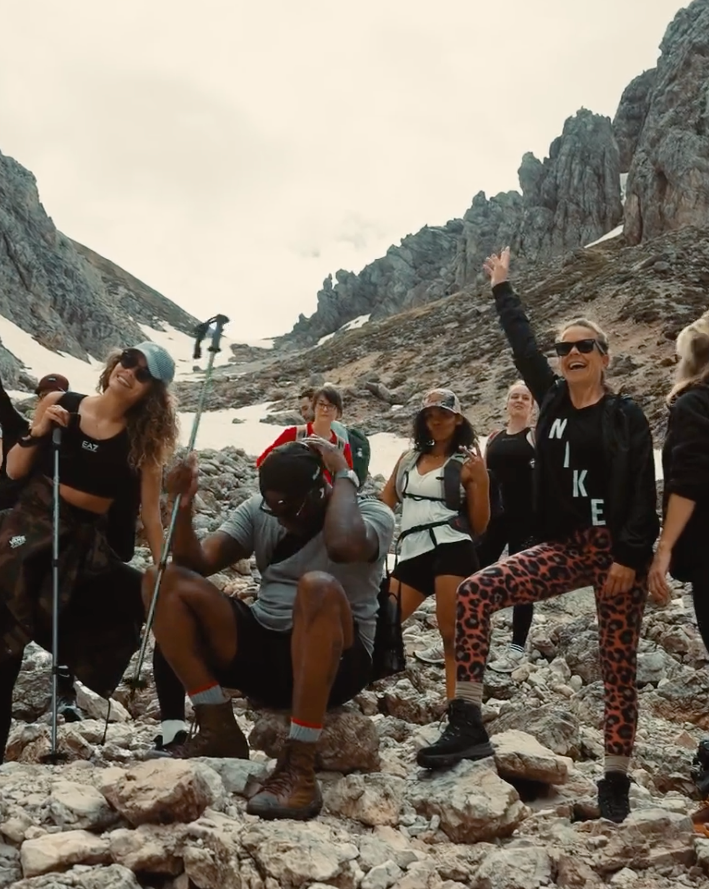 A group of people hiking through a scenic landscape, enjoying nature and the outdoors as they embark on a journey of exploration and teamwork.