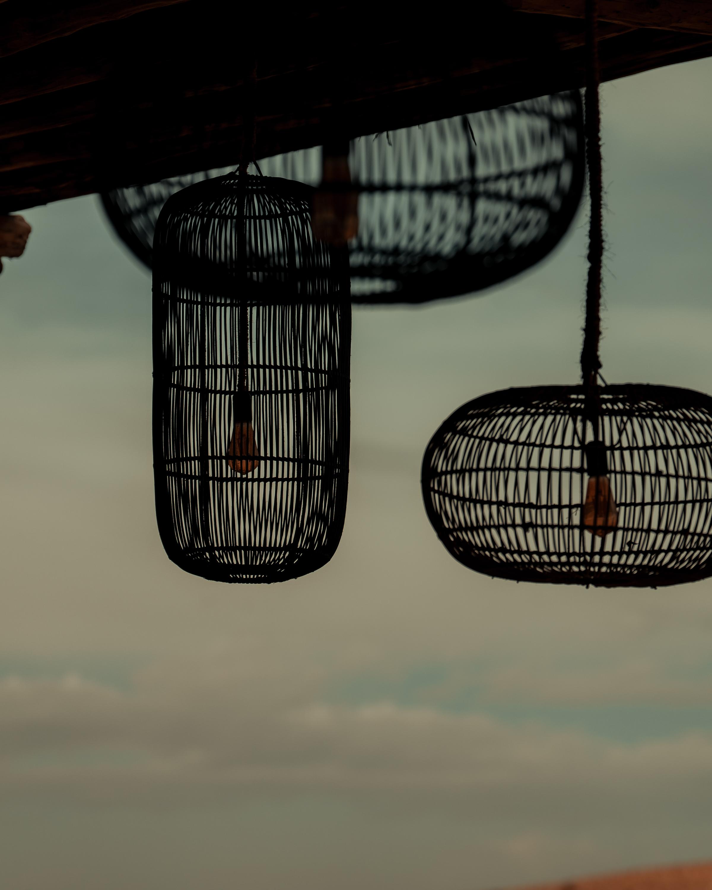 A moody sunset scene with a small, isolated church perched on a hill, illuminated by the warm glow of the setting sun. The expansive sky transitions from golden hues to dark, stormy clouds, creating a dramatic and tranquil atmosphere.