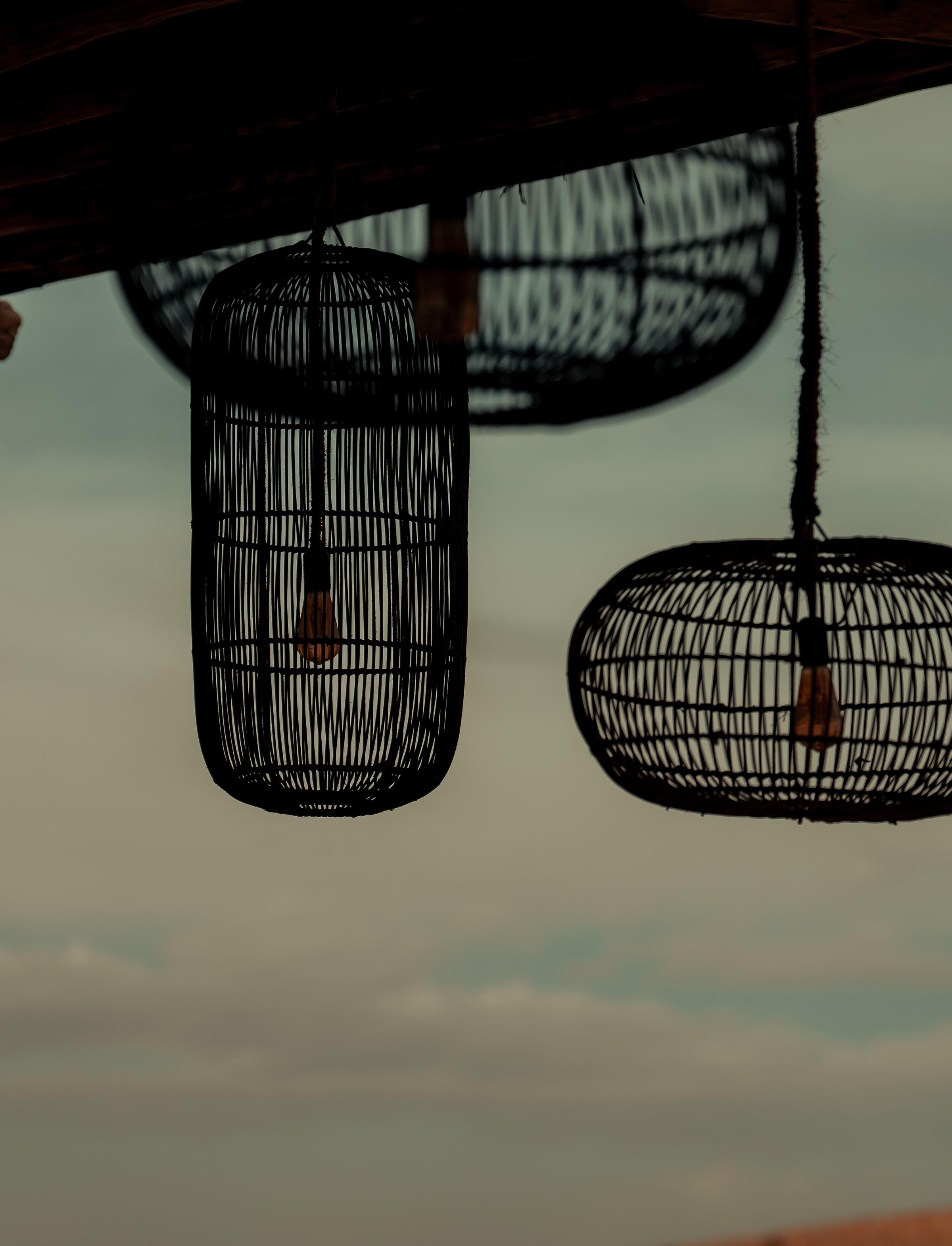 A moody sunset scene with a small, isolated church perched on a hill, illuminated by the warm glow of the setting sun. The expansive sky transitions from golden hues to dark, stormy clouds, creating a dramatic and tranquil atmosphere.