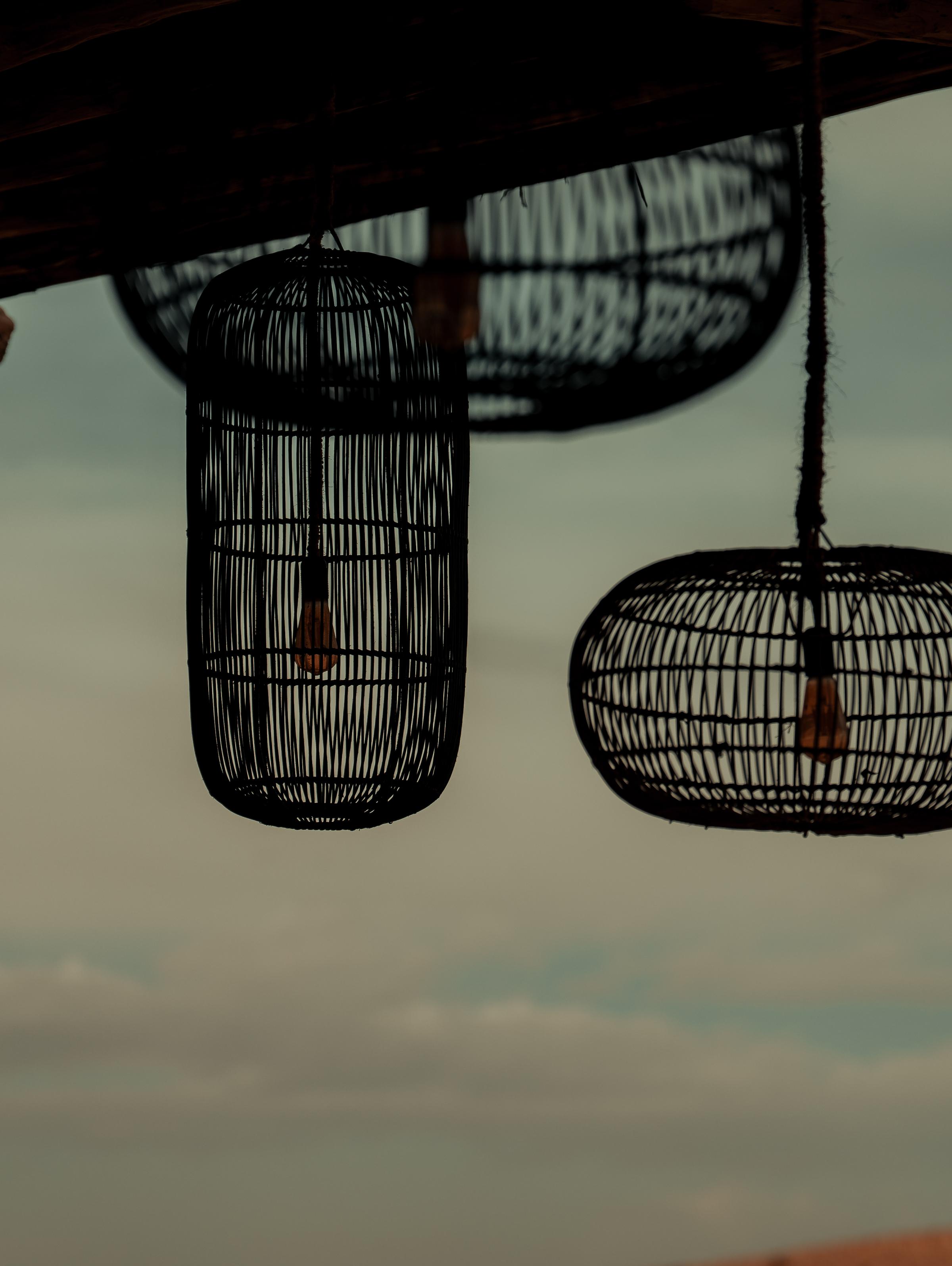 A moody sunset scene with a small, isolated church perched on a hill, illuminated by the warm glow of the setting sun. The expansive sky transitions from golden hues to dark, stormy clouds, creating a dramatic and tranquil atmosphere.