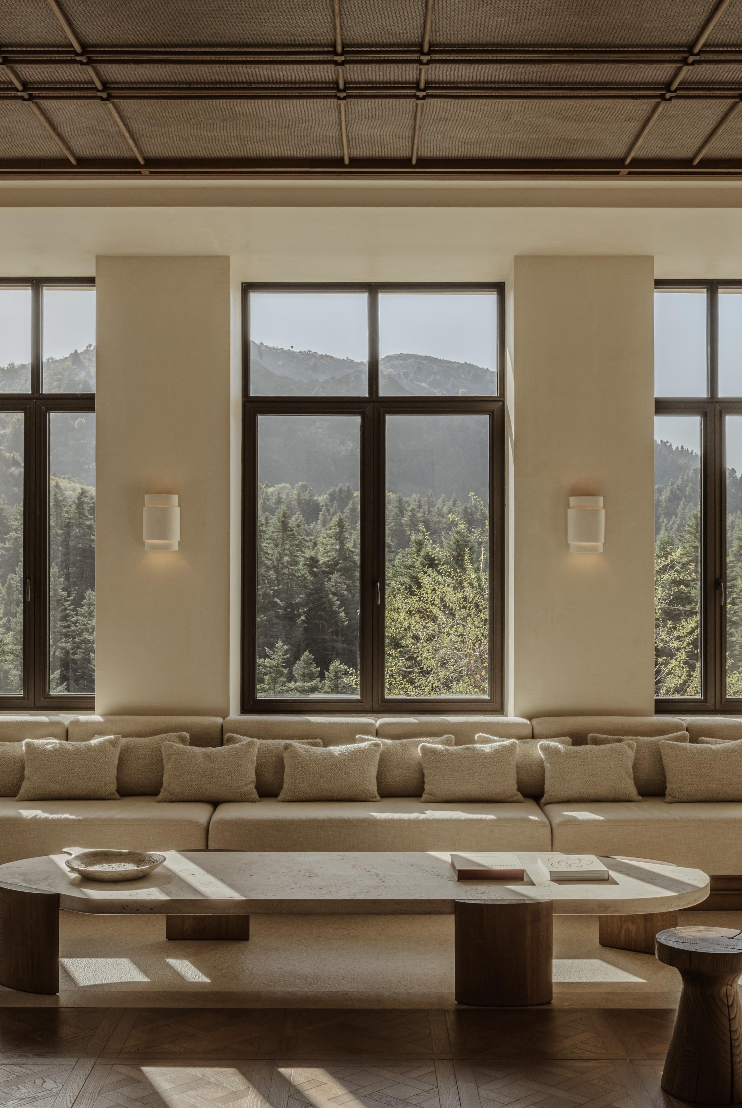 Scenic exterior of MANNA, a luxury mountain retreat nestled among ancient fir trees.