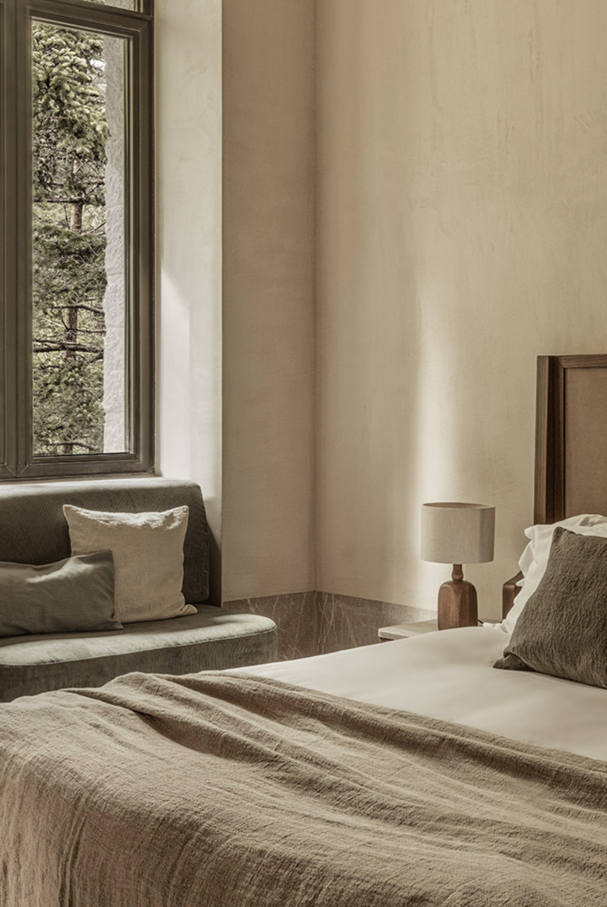Spacious guest room at MANNA, blending refined comfort with minimalist design and natural elements.