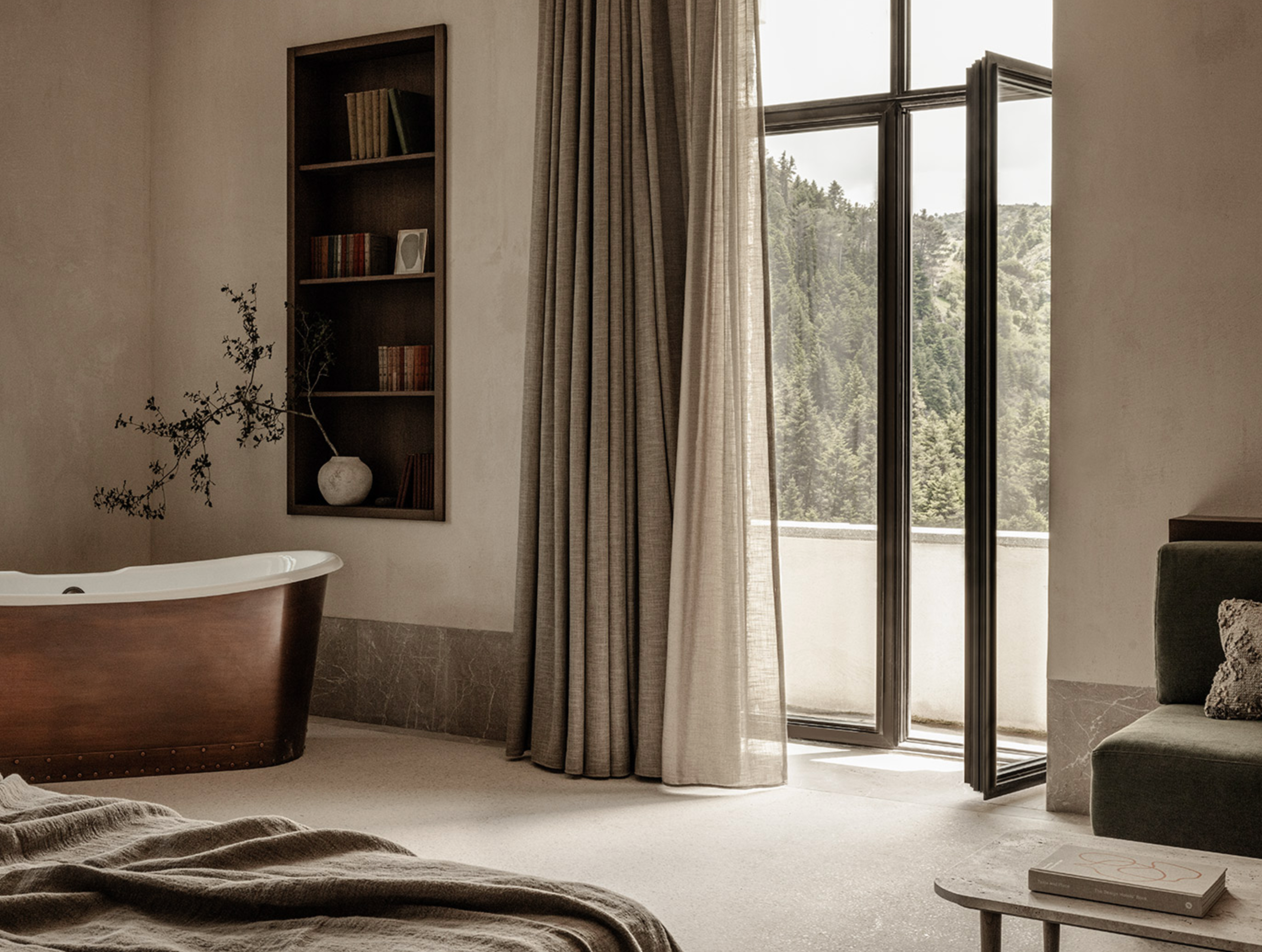 MANNA Suite offering generous space, stylish comfort, and panoramic views of the surrounding evergreen forests.