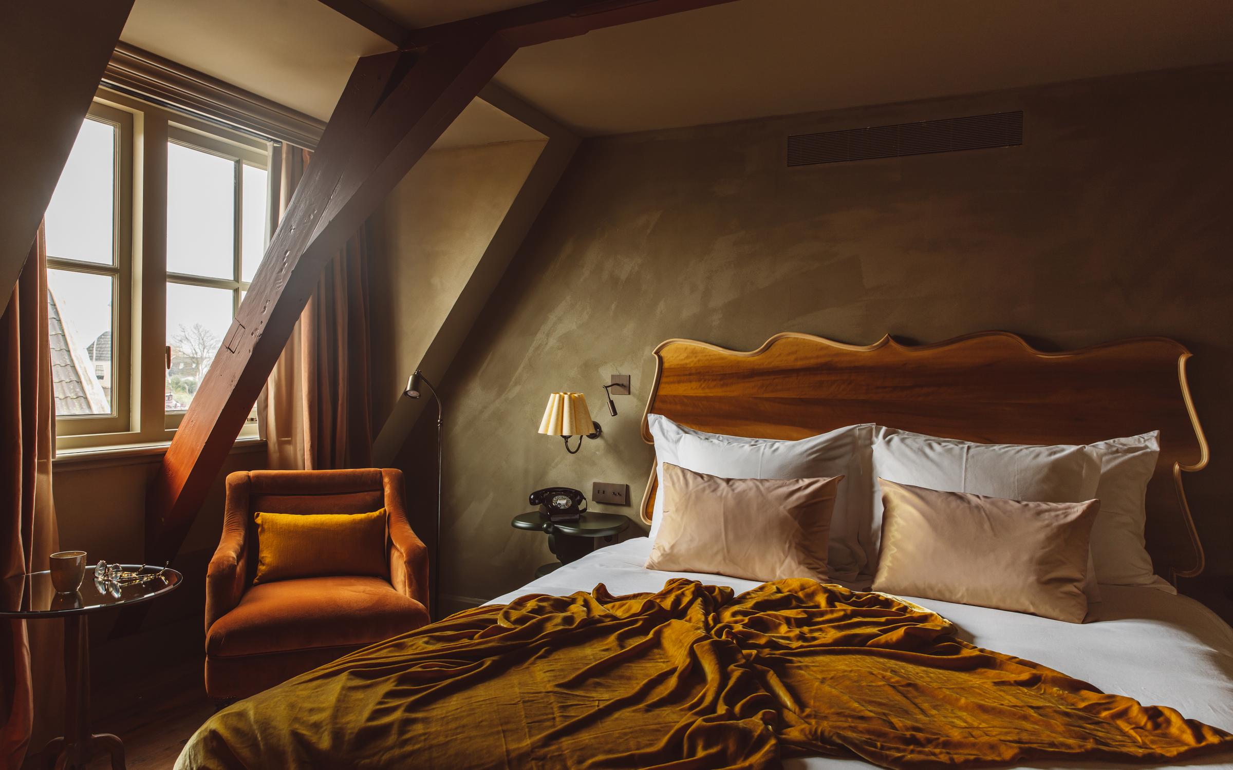 Unwind Dutch-style: soft velvet throws, bespoke ceramics, and serene lake views make every room at The Durgerdam your personal haven.