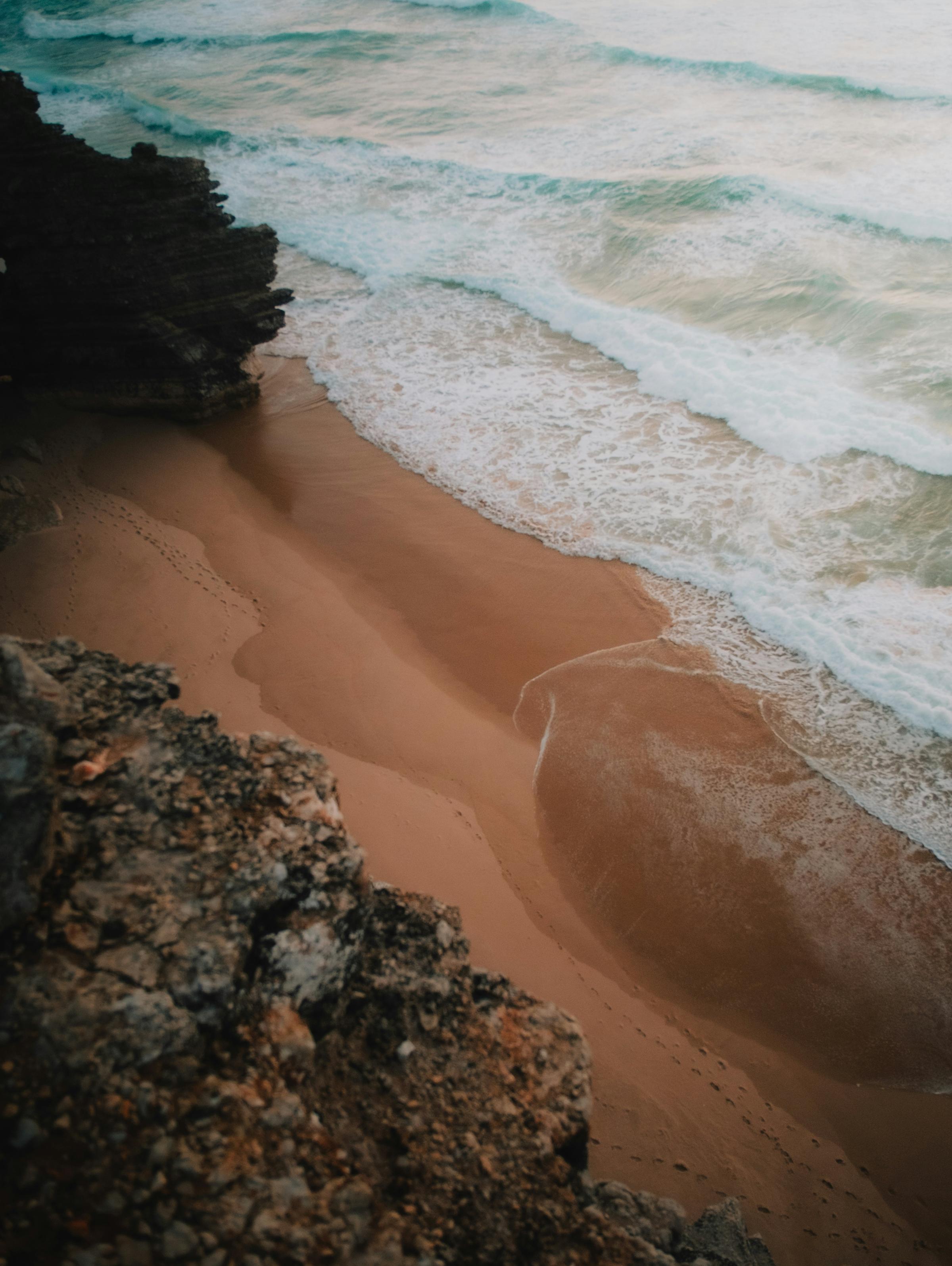 An aerial view of a secluded island, surrounded by vibrant turquoise waters and white sandy beaches, showcasing the beauty of tropical paradise.