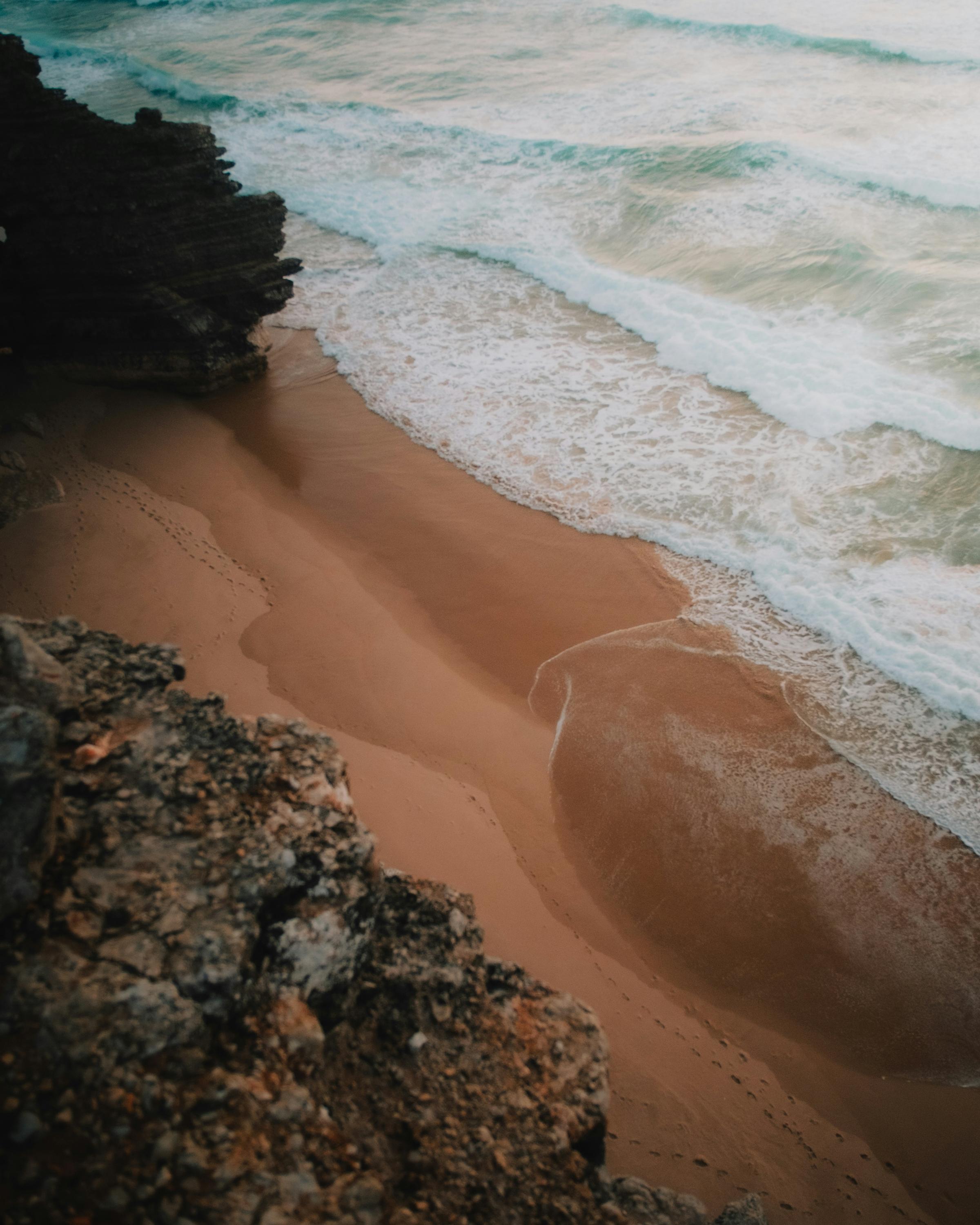 An aerial view of a secluded island, surrounded by vibrant turquoise waters and white sandy beaches, showcasing the beauty of tropical paradise.