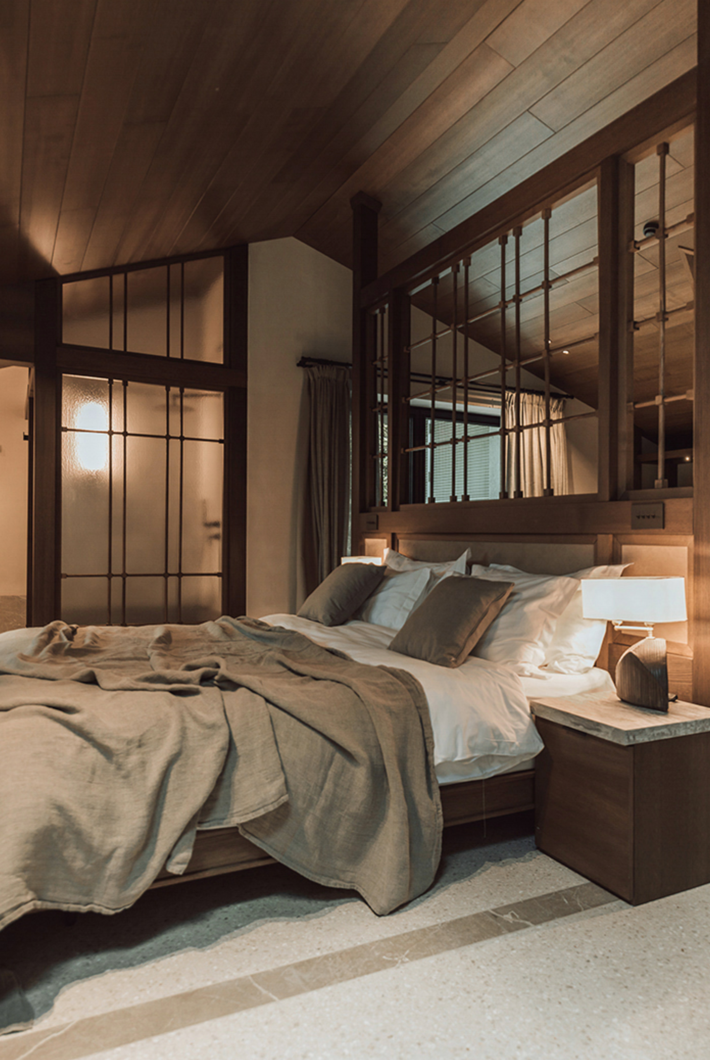 Spacious MANNA Suite showcasing refined luxury, elegant furnishings, and expansive forest views.