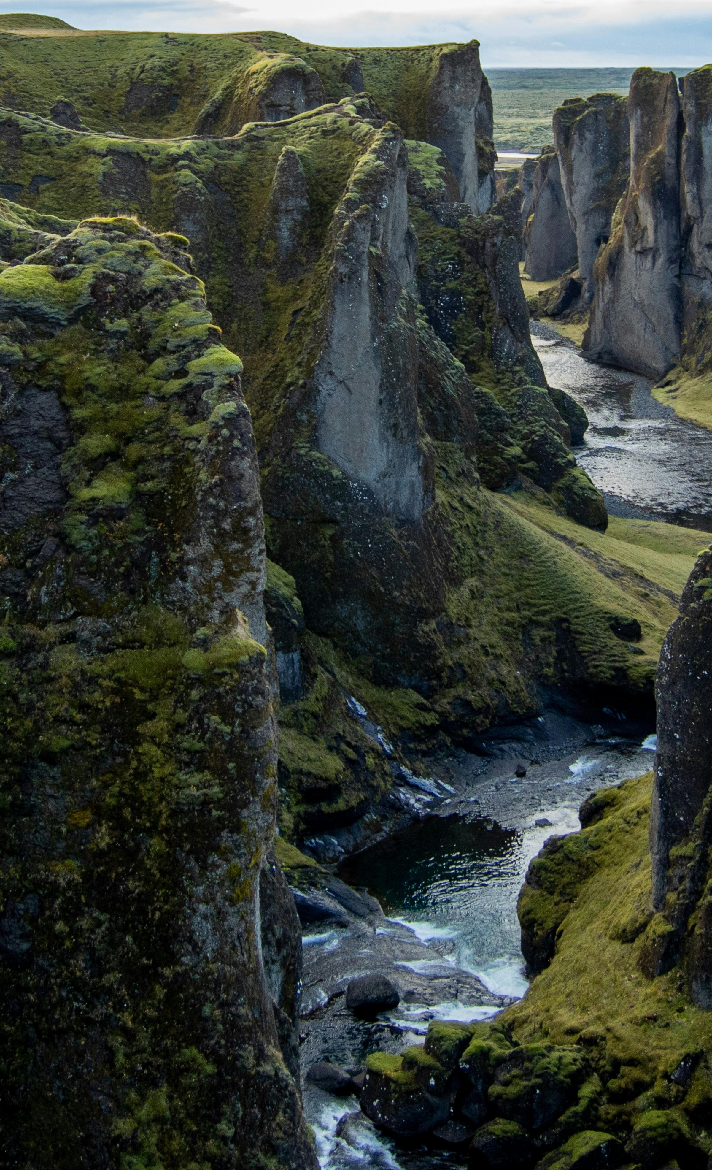 Frozen alpine lake surrounded by snowy peaks at sunrise