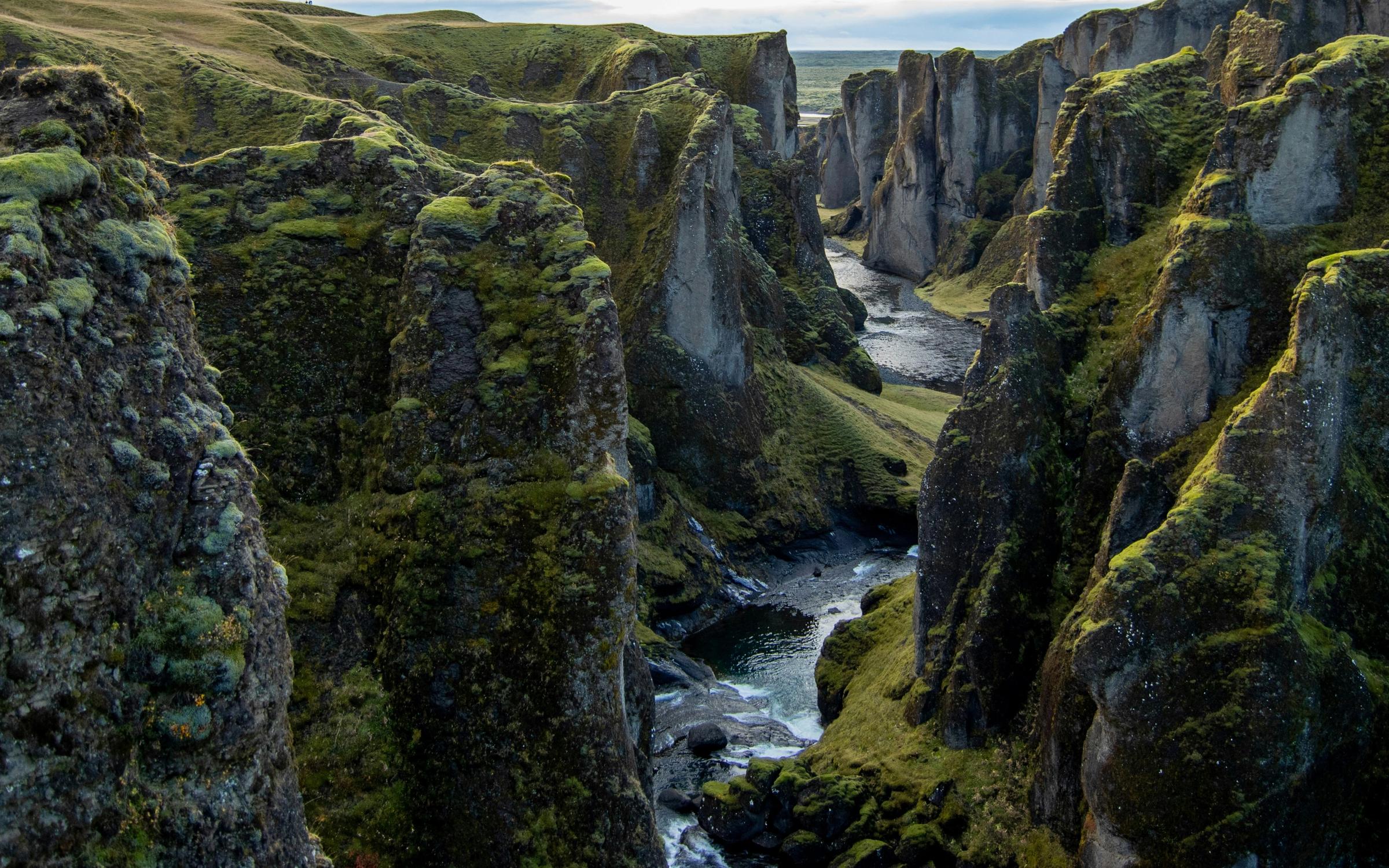 Frozen alpine lake surrounded by snowy peaks at sunrise