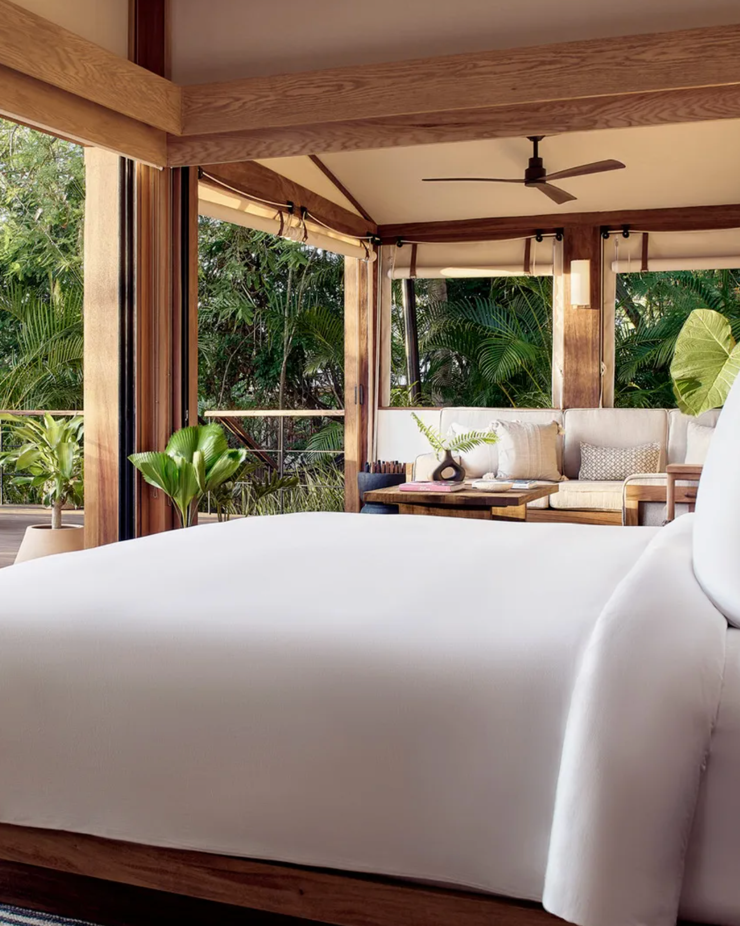 The cozy yet sophisticated interior of a luxury tent with rich wooden accents, custom decor, and soft lighting that reflects the surrounding environment.