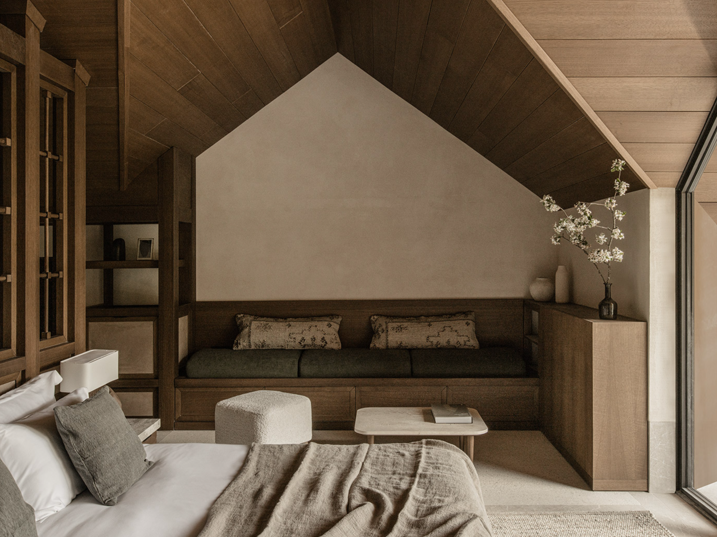 Warm and inviting Junior Suite at MANNA with elegant furnishings, plush bedding, and tranquil mountain surroundings.