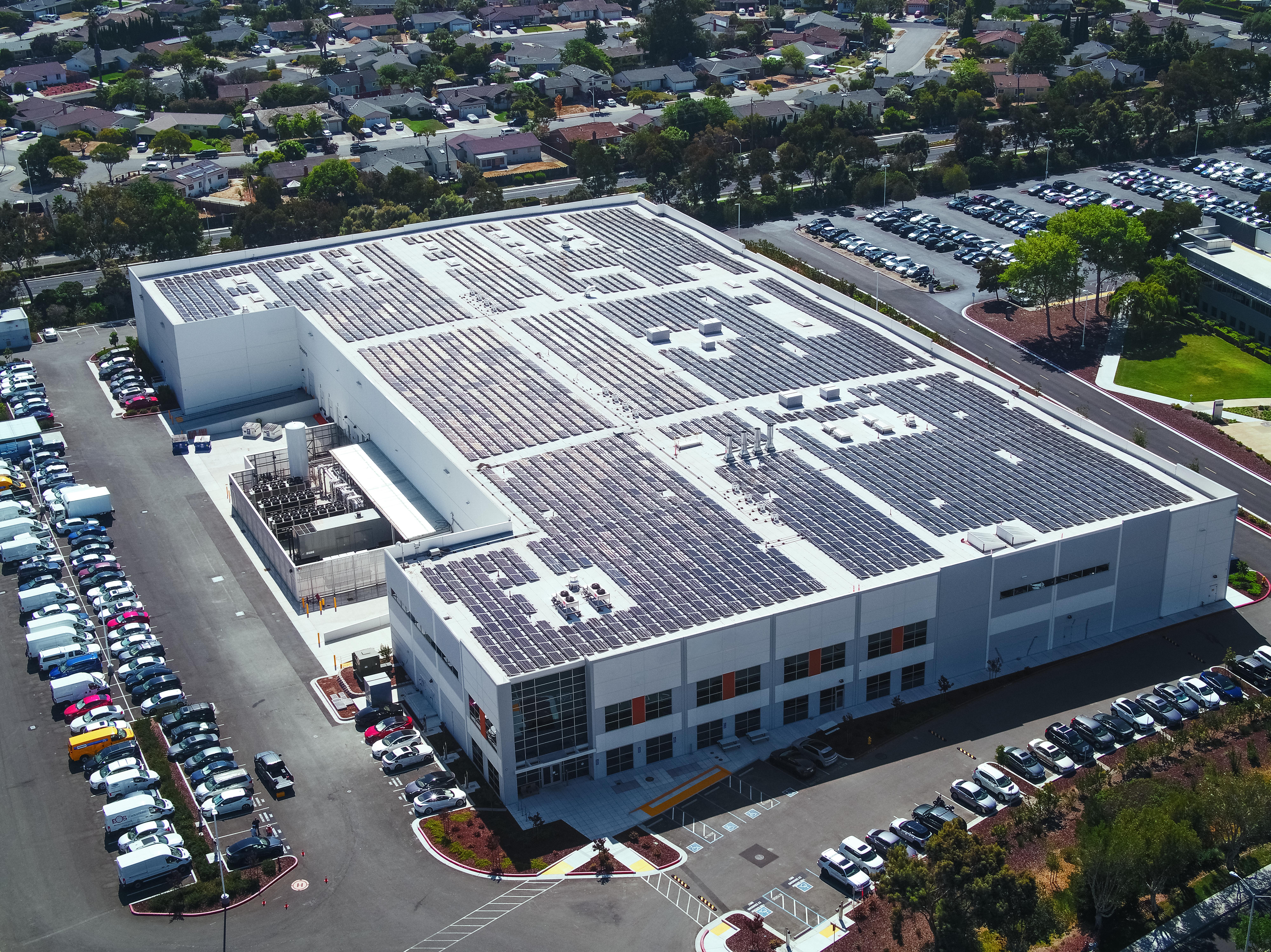 Drone view of commercial facility with solar panels installed on roof in California - Onyx Renewables
