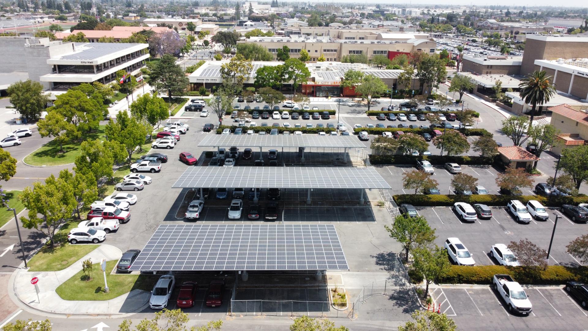 Drone view of municipal library with solar panels installed on parking lot carports in California - Onyx Renewables
