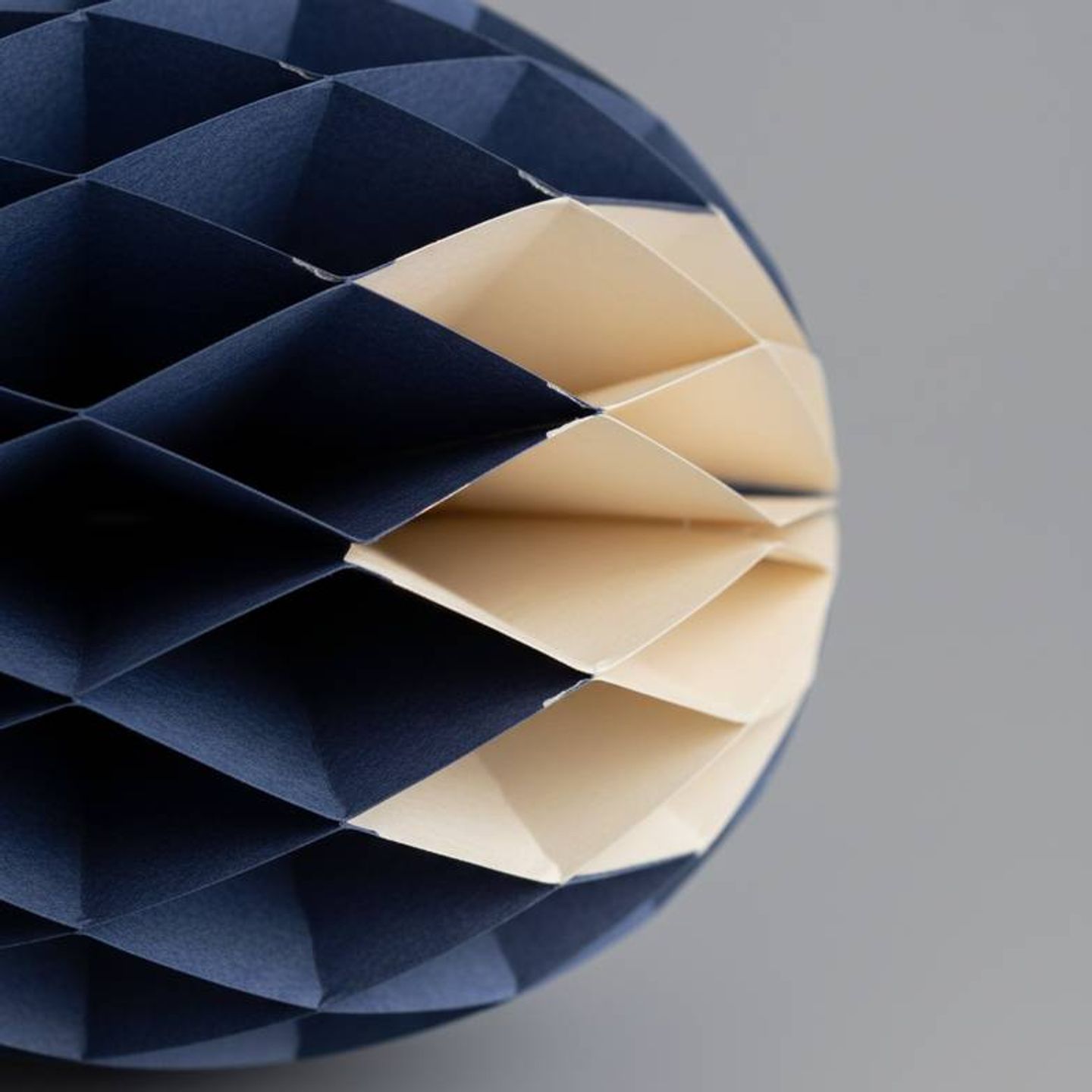 Close-up of the cellular structure of honeycomb paper decorations.