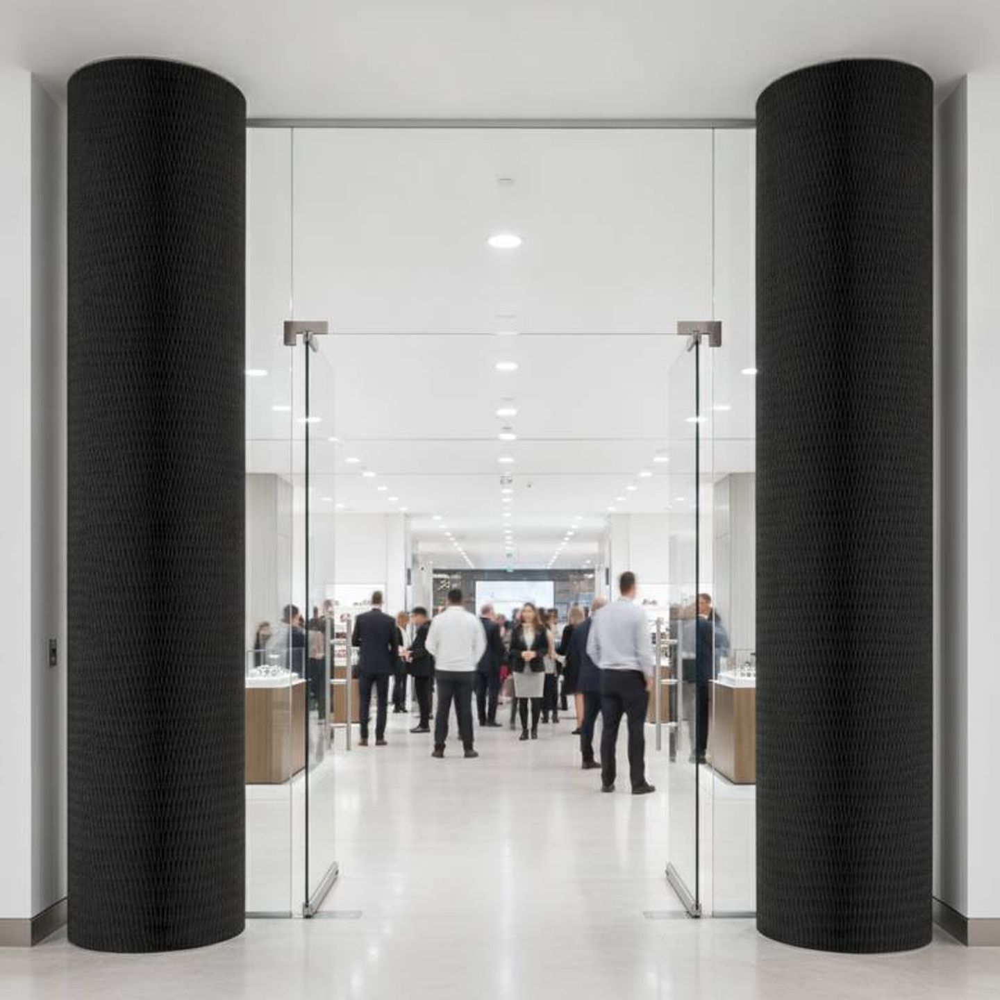 Durable honeycomb paper columns framing a busy store entrance, showing their stability.
