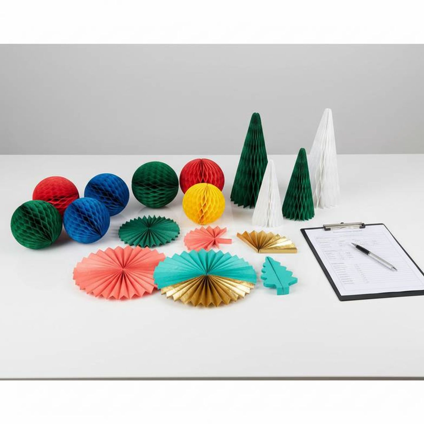 A collection of colorful honeycomb paper decoration samples on a workbench for inspection