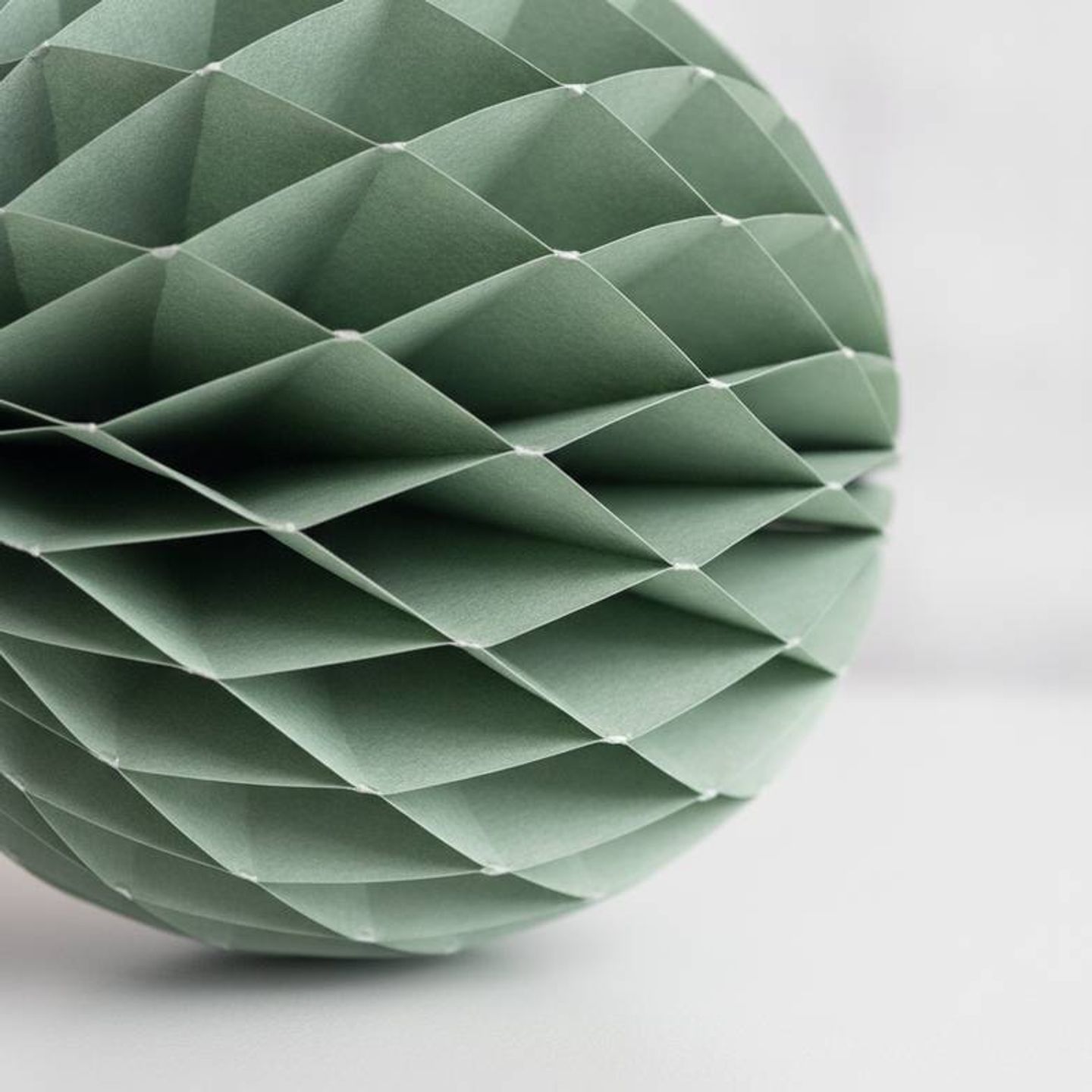 A close-up of reusable honeycomb paper decorations showing their detailed paper structure