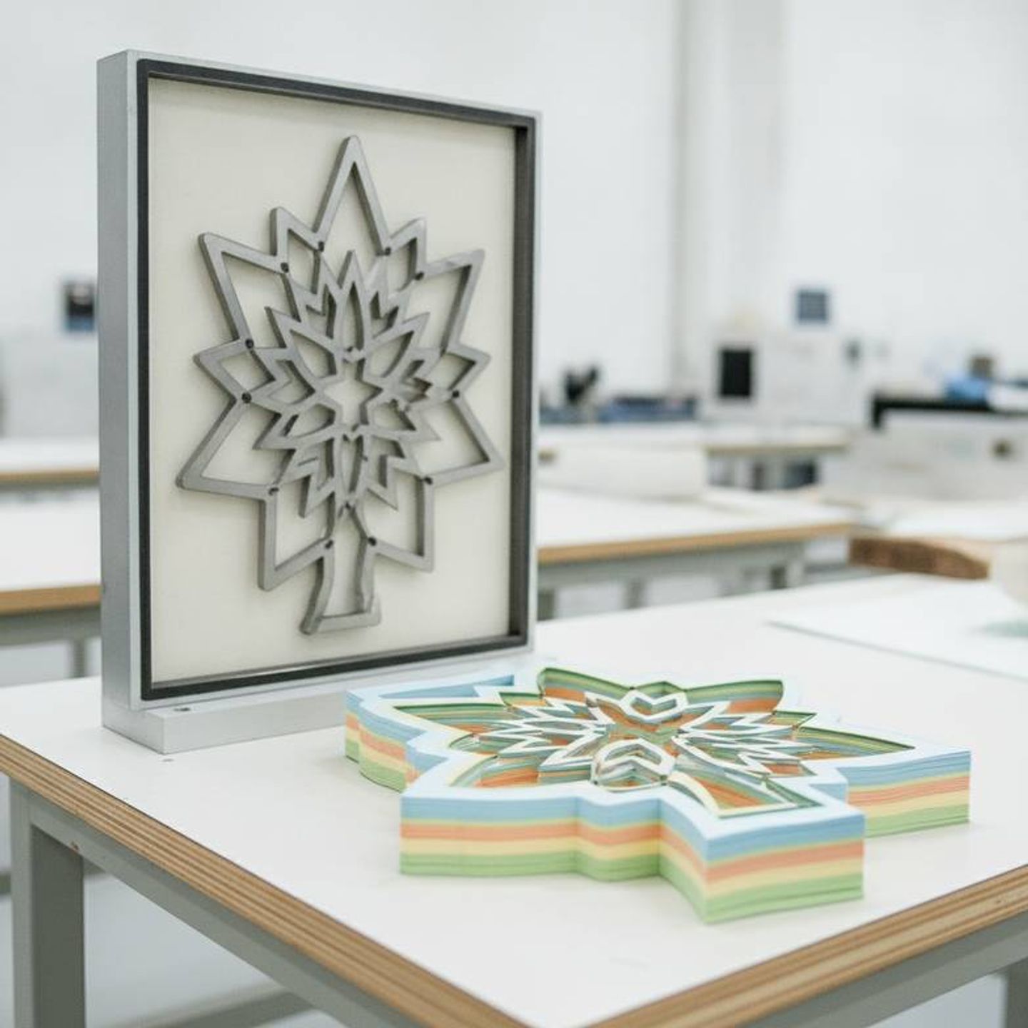 A die-cutting tool next to a stack of cut paper for wholesale honeycomb paper decorations.