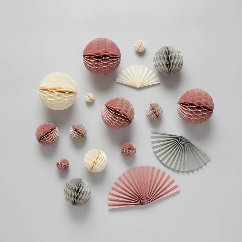 A cohesive seasonal decoration assortment featuring honeycomb paper ornaments and tabletop pieces.