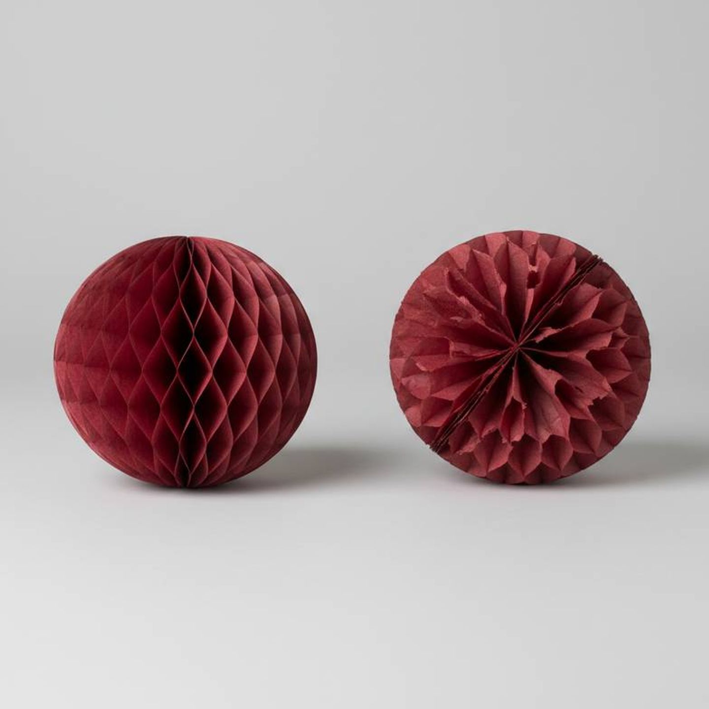 Close-up of a high-quality honeycomb paper structure next to a flimsy, poorly made one