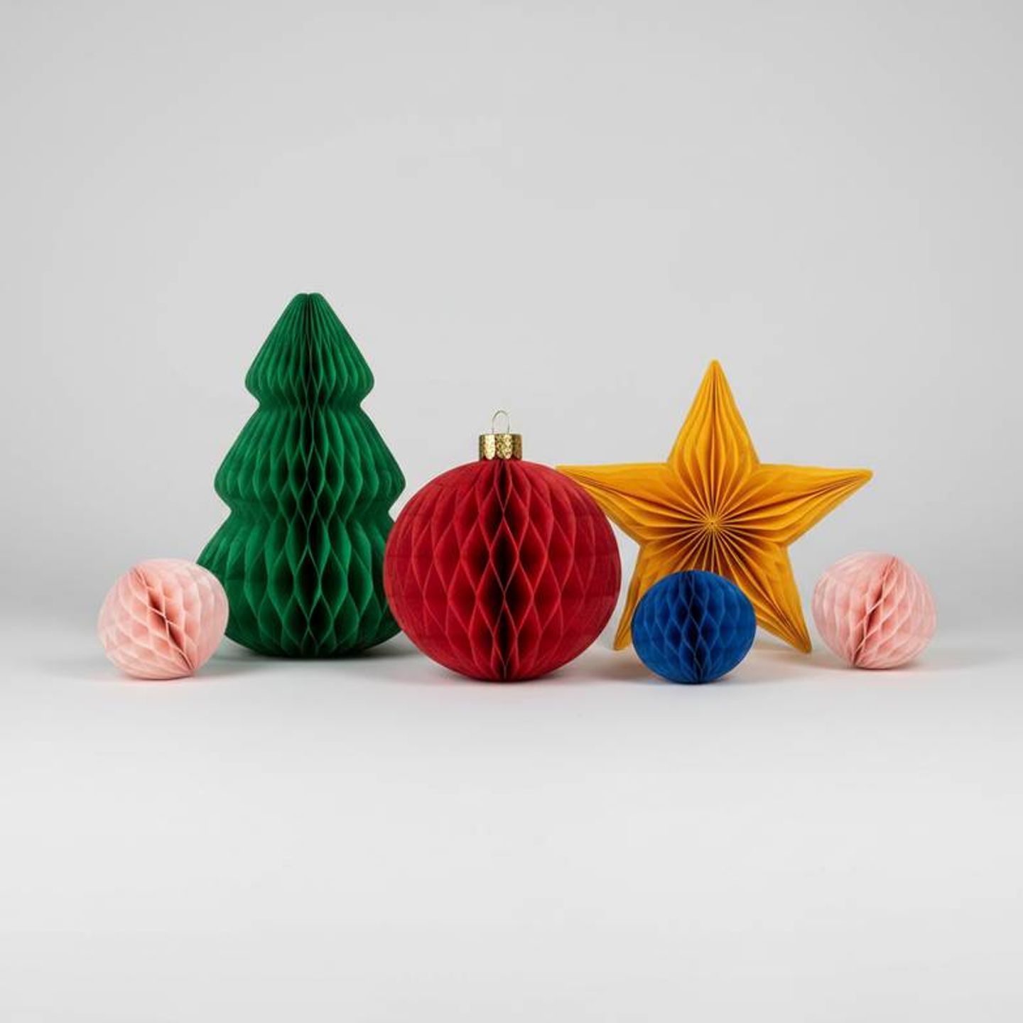 A collection of colorful ODM honeycomb paper decorations ready for private labeling.