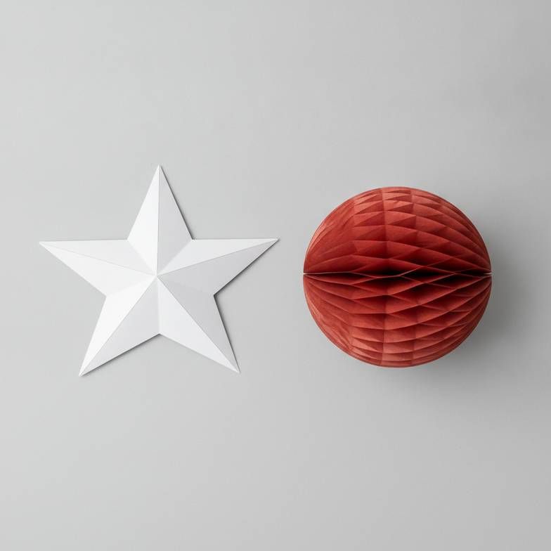 A side-by-side comparison showing a simple folded paper star and a complex honeycomb paper ball.