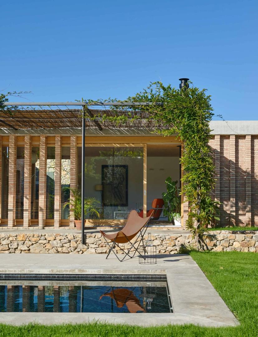 Vista del jardí, piscina i façana interior de la casa unifamiliar Casa AA al Baix Empordà