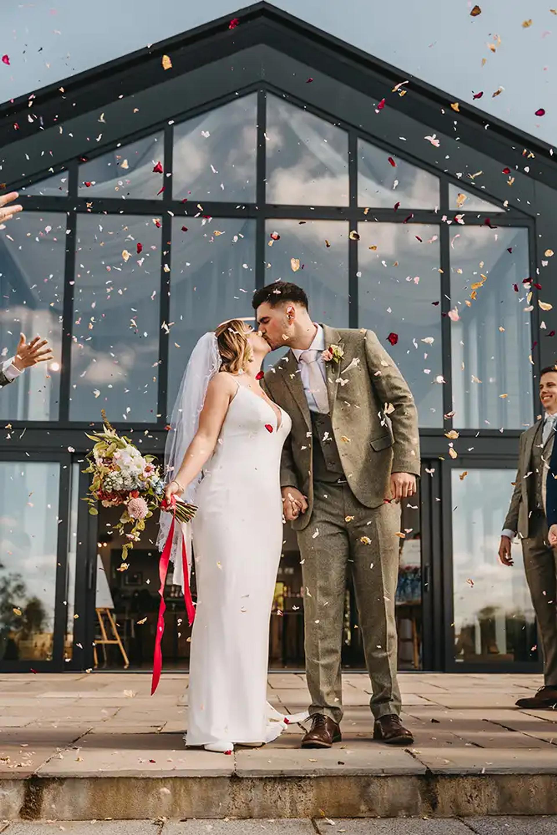 Couple standing in front of the wedding venue