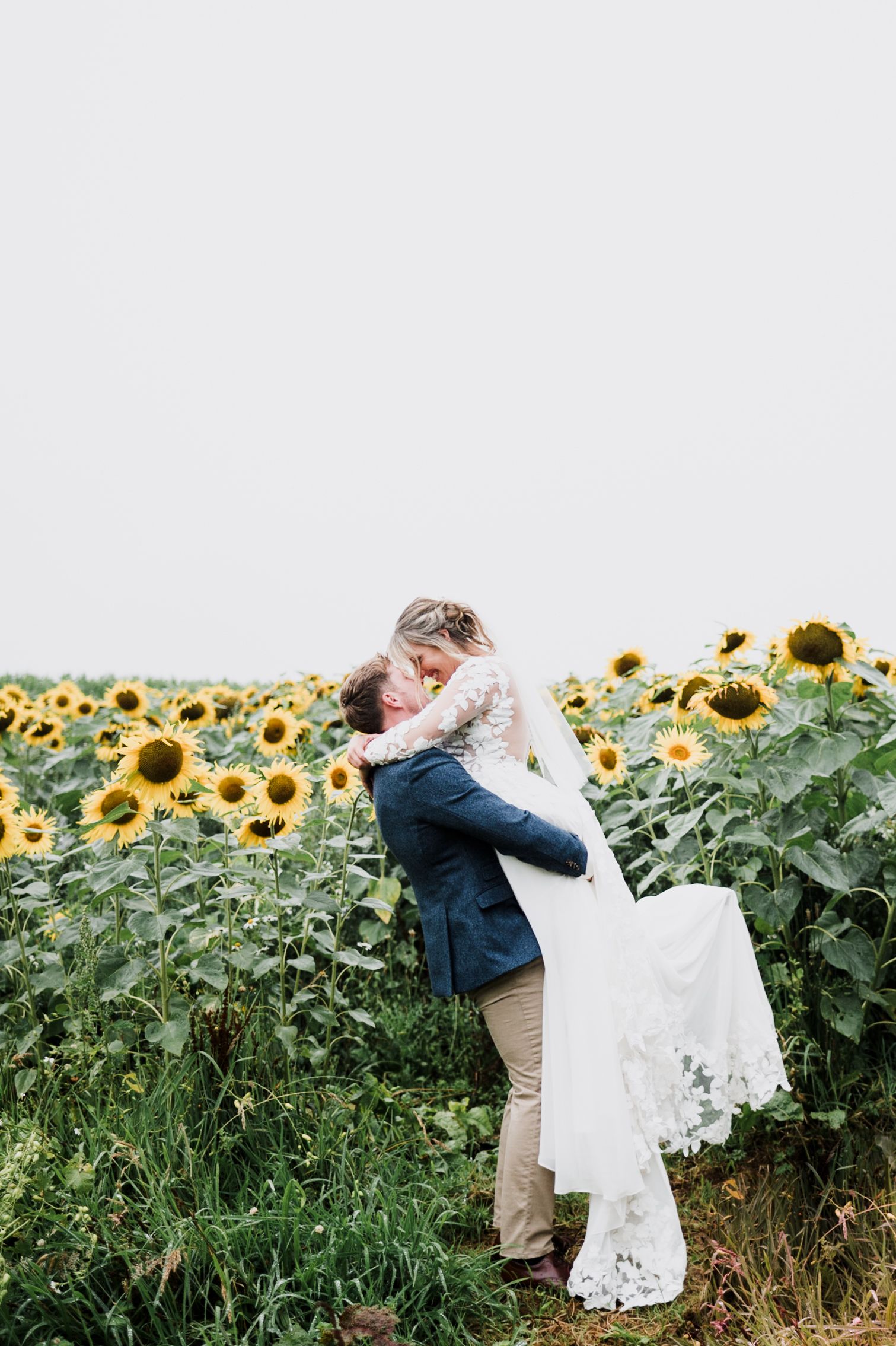 A couple embracing each other in the sunflower field