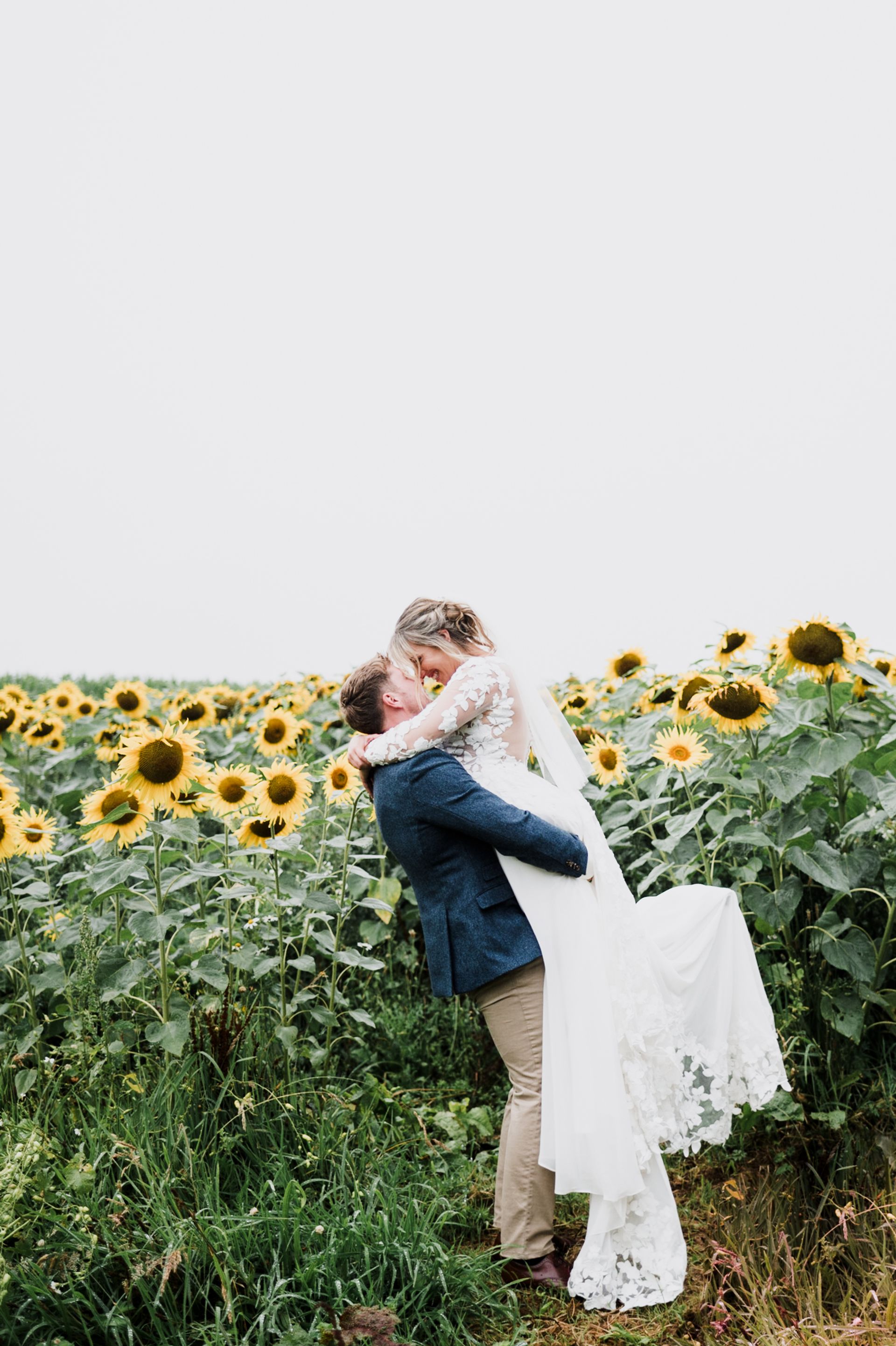 A couple embracing each other in the sunflower field
