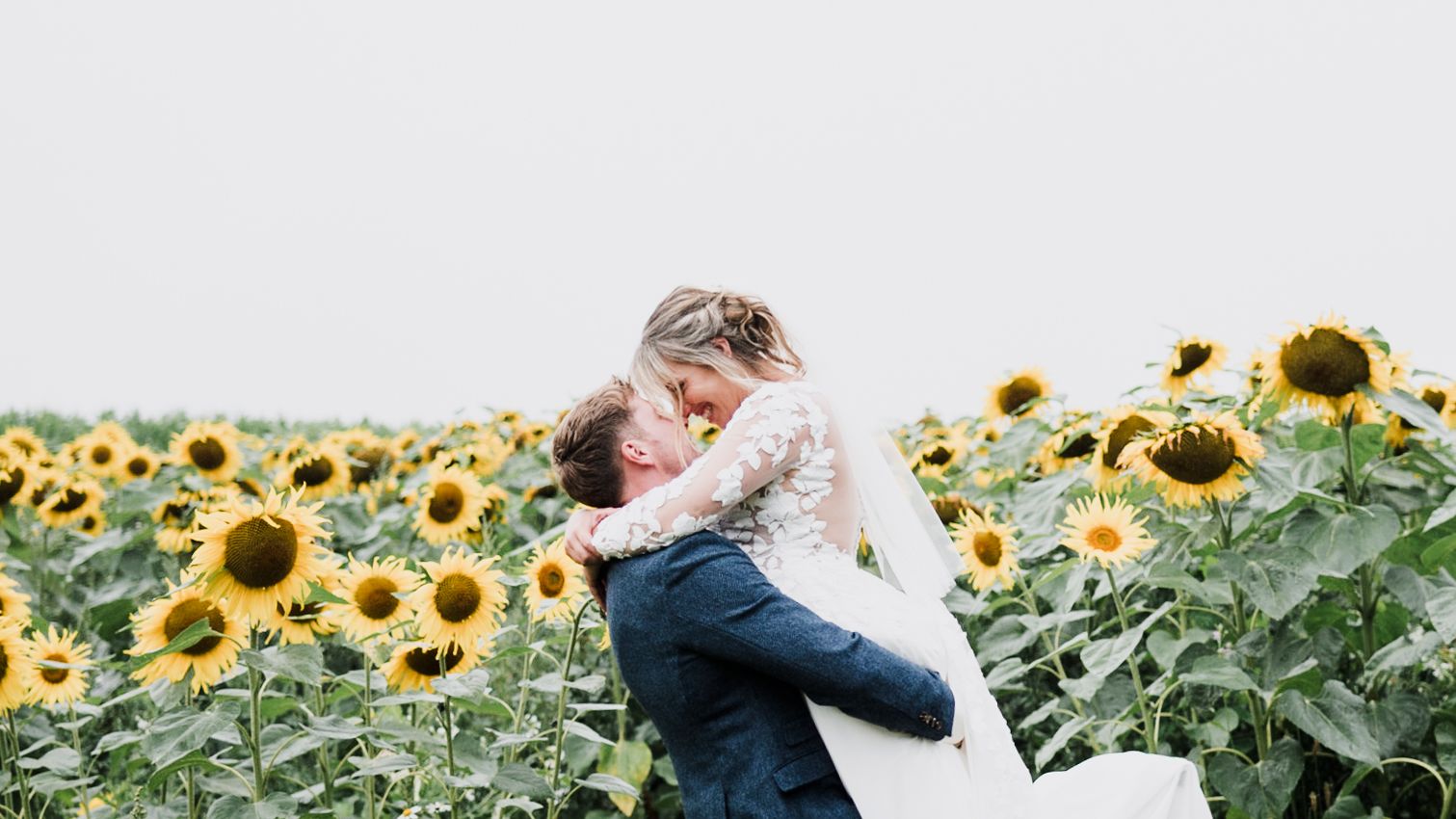 A couple embracing each other in the sunflower field