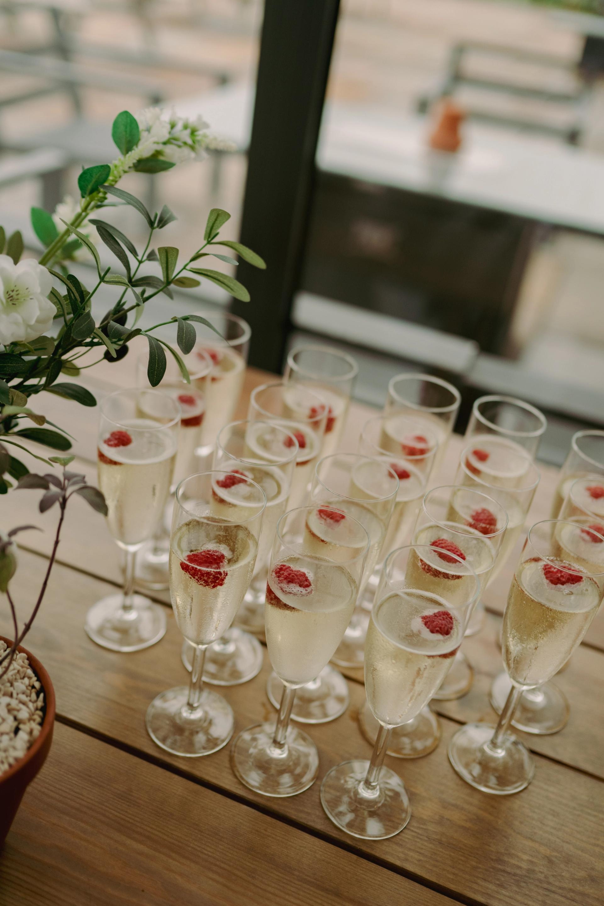 A selection of Prosecco glasses neatly arranged on a table as part of the wedding welcome drinks setup