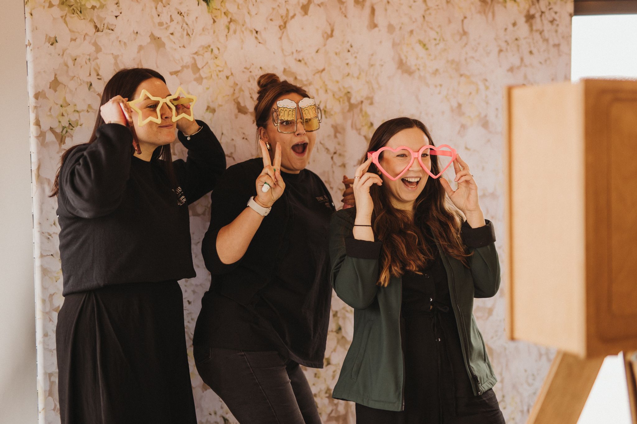 Team members posing for a photo wearing oversized glasses