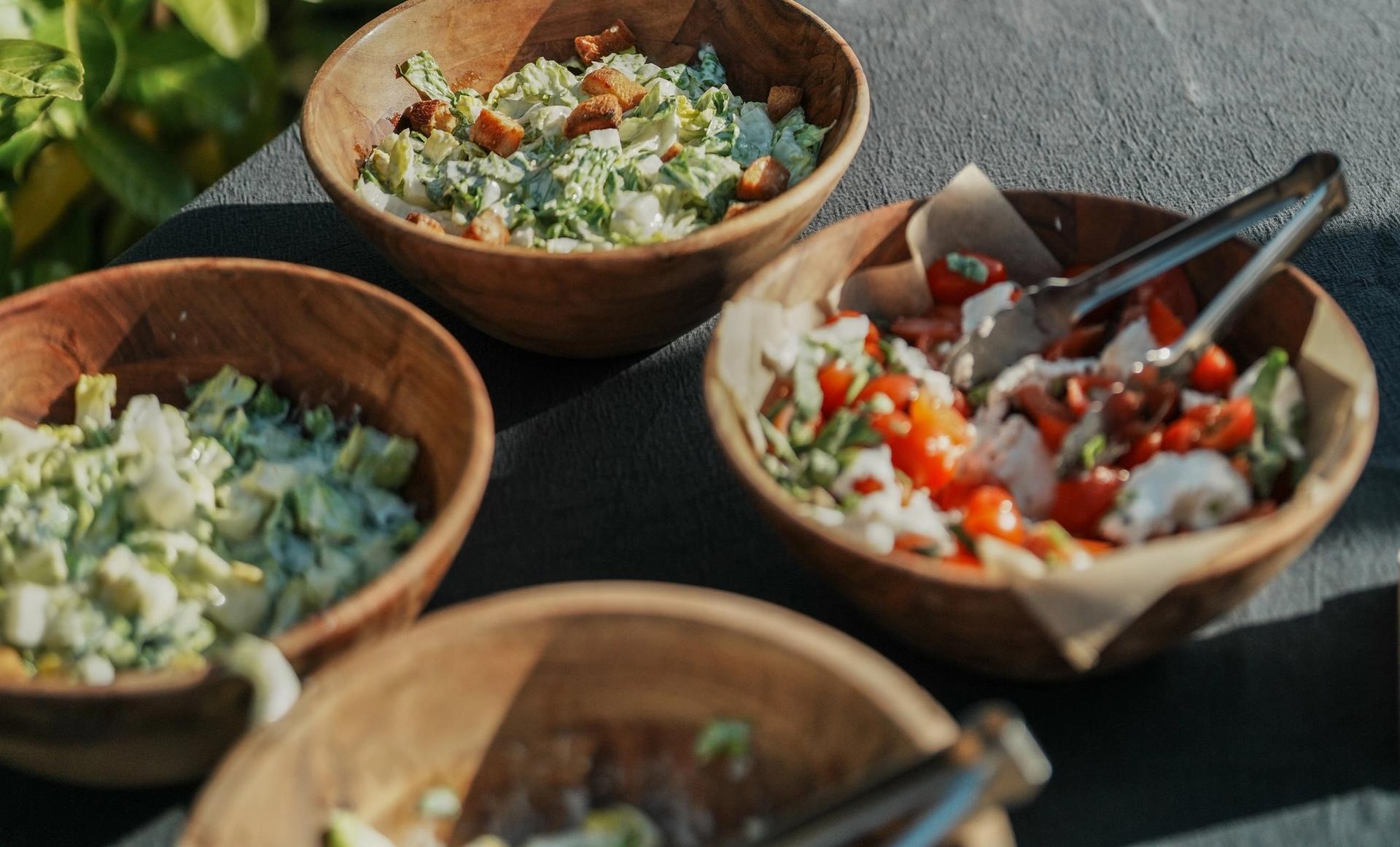 A table showing a selection of fresh salads and sides