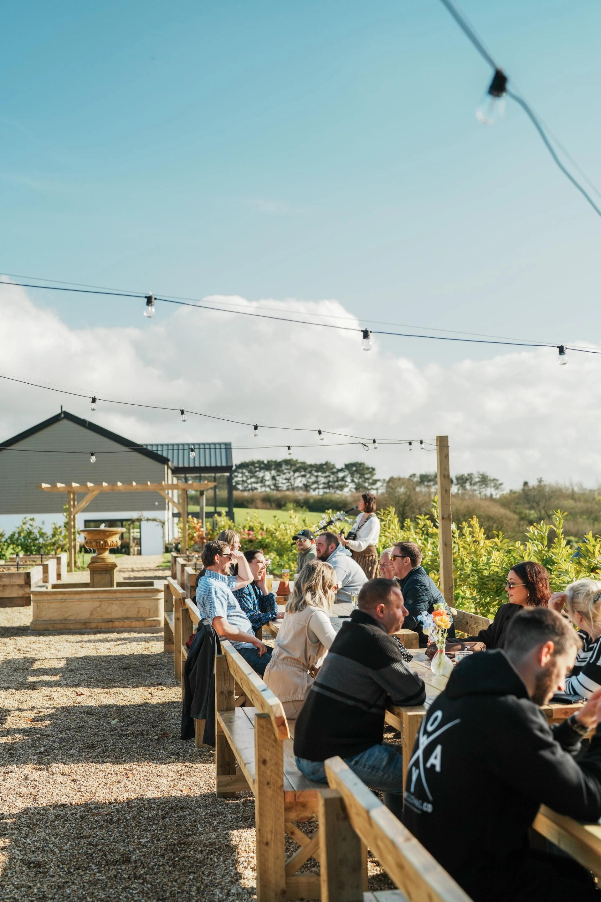 People sitting at the tables in the kitchen garden