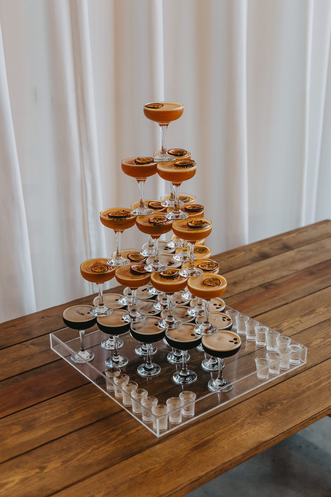 A cocktail tower arranged on top of a table.